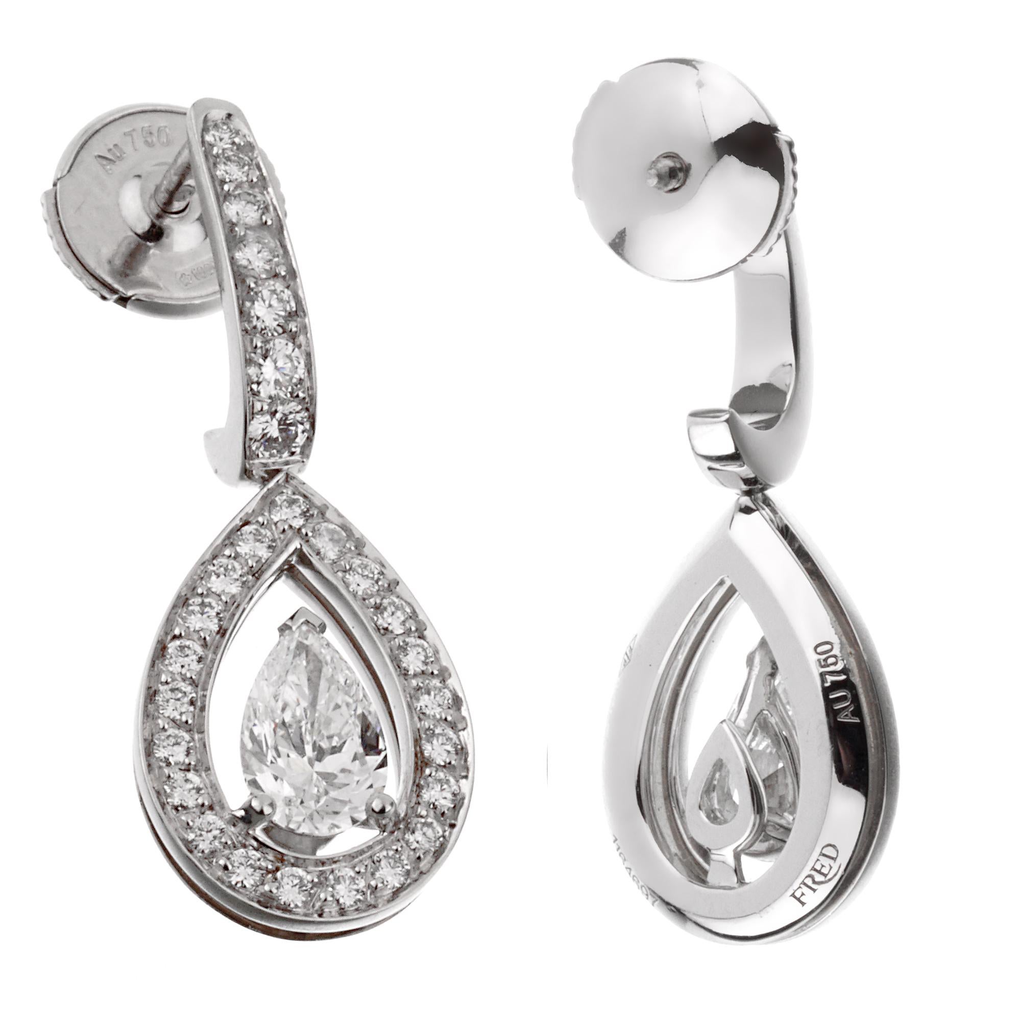 A stunning pair of Fred of Paris diamond drop earrings, each earring showcases a .51, and .52ct central pear shaped diamond adorned with round brilliant cut diamonds in shimmering 18k white gold. Each central pear shaped diamond is accompanied with