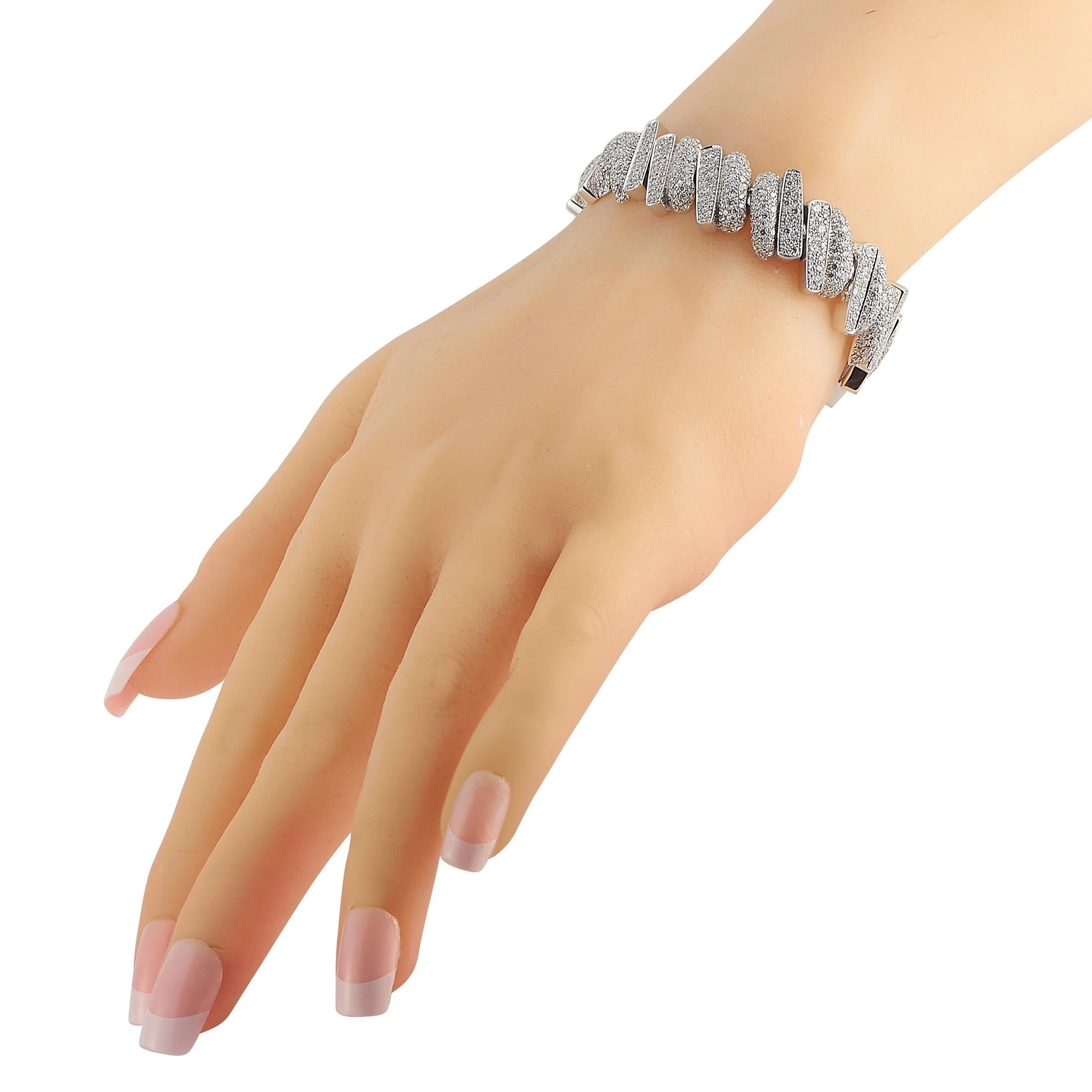 Stunning and artistic in design, this Fred of Paris Success bracelet will radiate light. Covered in diamonds totaling 7.96 carats, it’s crafted from 18K White Gold for added luxury. It measures 6.5” long. 