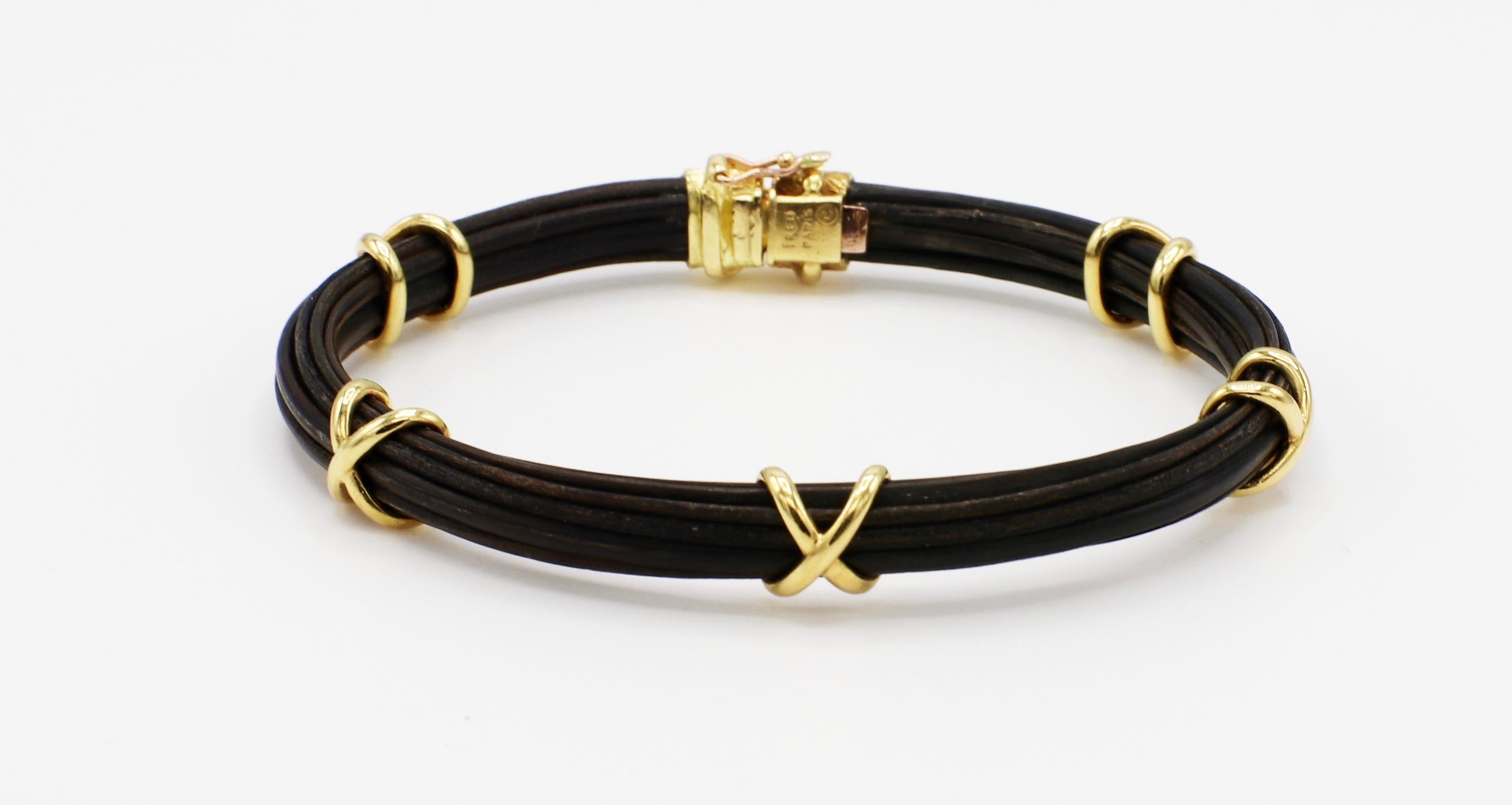 Fred Paris 18 Karat Yellow Gold Elephant Hair Bangle Bracelet 

Metal: 18K yellow gold
Weight: 10.3 grams
Diameter: 2.5 inches
Length: Approx. 6.5 inches
Width: Approx. 6.5mm 
