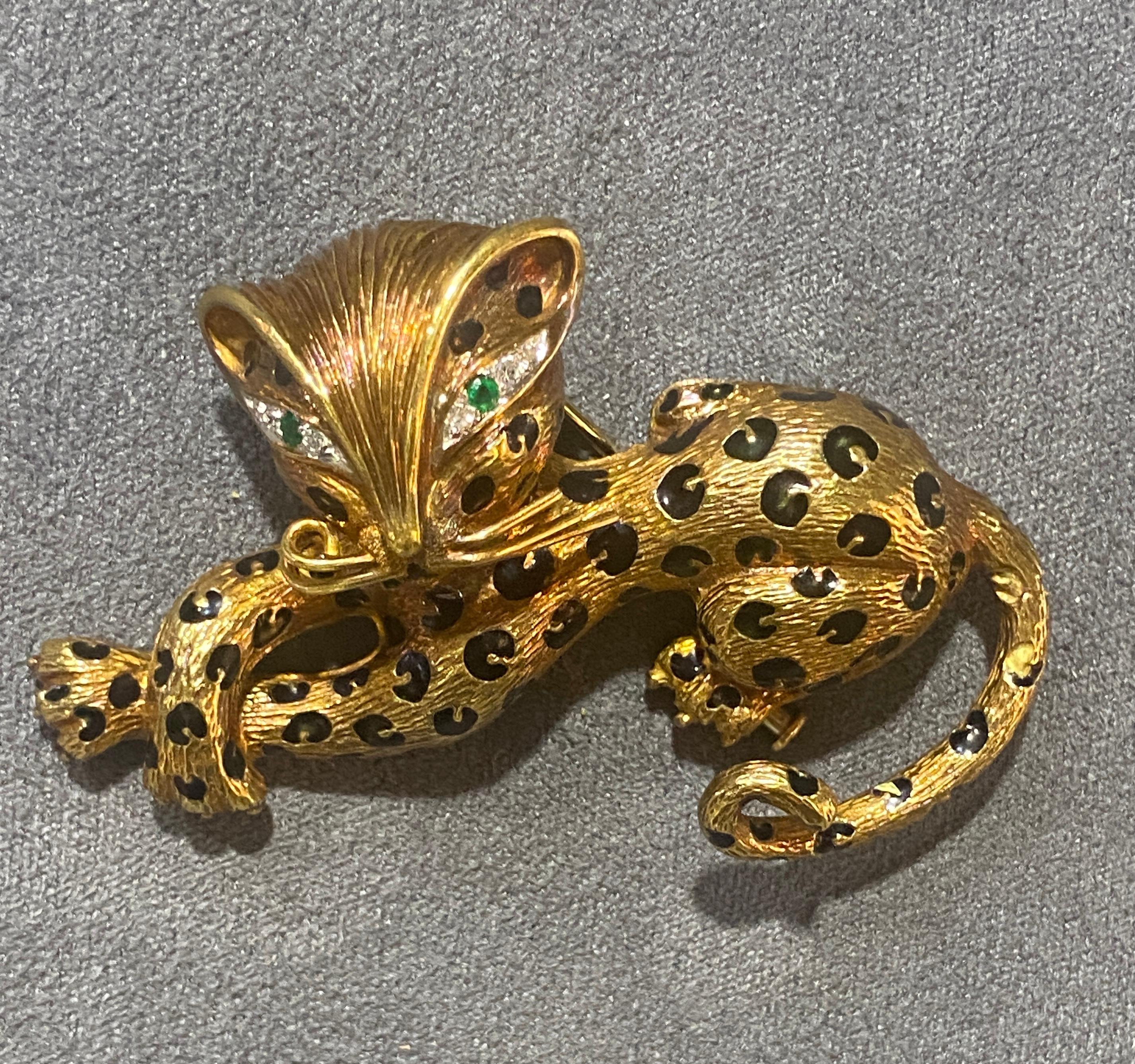 This charming panther brooch by Fred Paris dates back to 1960s and is made of 18k gold. The panther's spots are enameled and its eyes are adorned with round cut diamonds and emeralds. A delightful addition to your collection and one that is highly