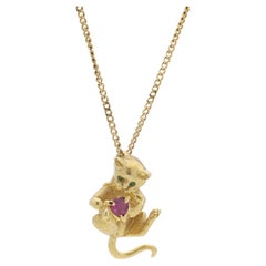 Fred Paris 18kt. yellow gold chain necklace with kitty holding ruby pendant
