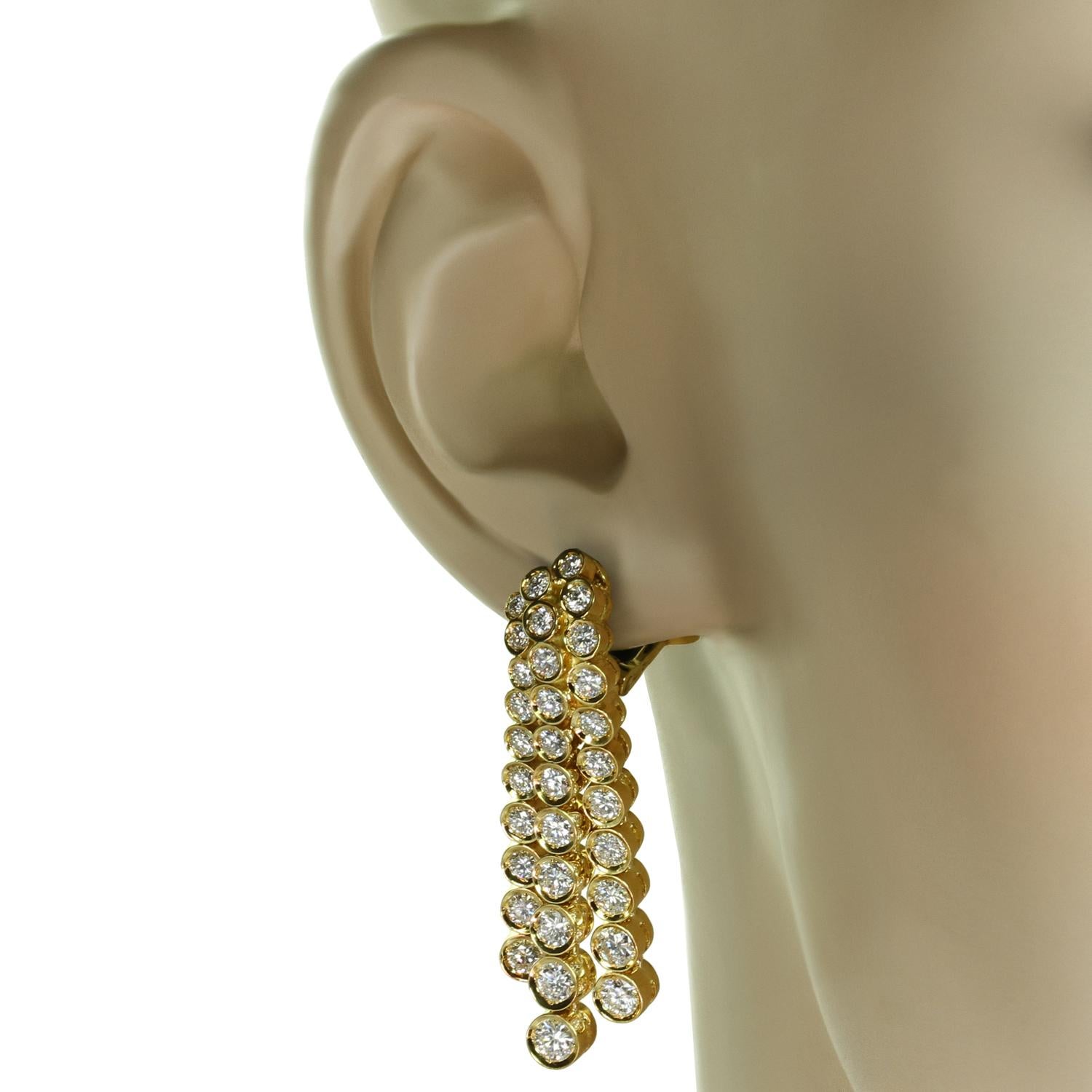 These gorgeous Fred Paris clip-on earrings feature a cascade chandelier design crafted in 18k yellow gold and set with round brilliant E-F-G VVS2-VS1 diamonds weighing an estimated 4.50 - 5.0 carats. Made in France circa 1980s. Measurements: 1.41