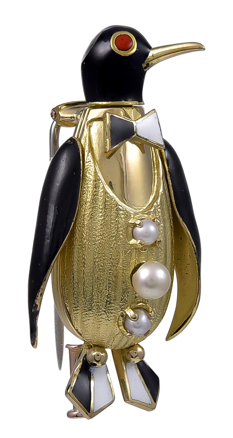 Our perky penguin is ready to go out on the town for New Year's Eve.  This charming clip was made and signed by FRED PARIS. 
18K yellow gold, with deco black and white enamel  bow-tie and shoes, black wings and head, and orange enamel eyes.  Set