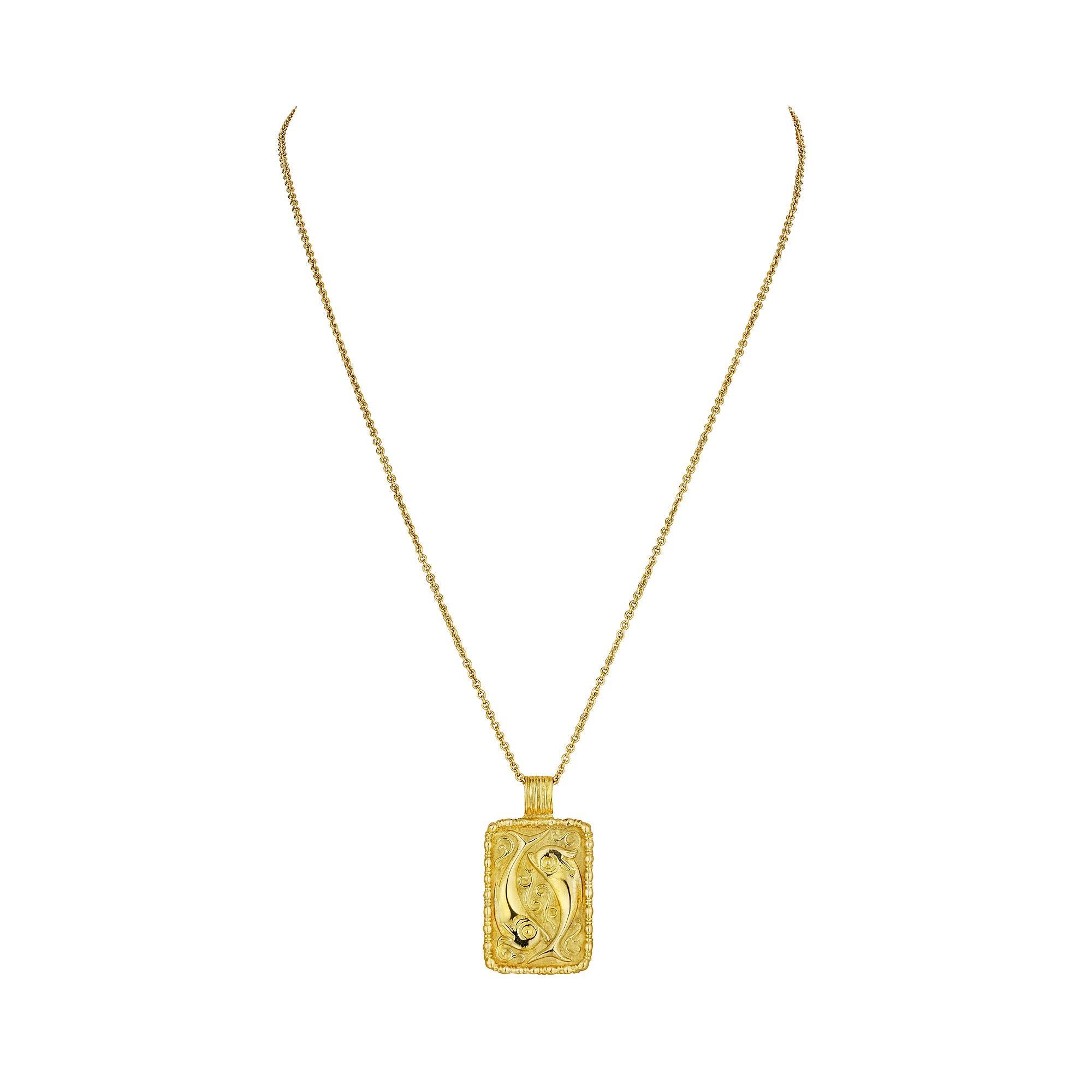 The Pisces zodiac symbol are fish which are known to swim upstream, against the current, showing great strength and stamina. This powerful Fred Paris Pisces zodiac vintage 18 yellow gold small rectangular plaque pendant, with engraved swimming fish