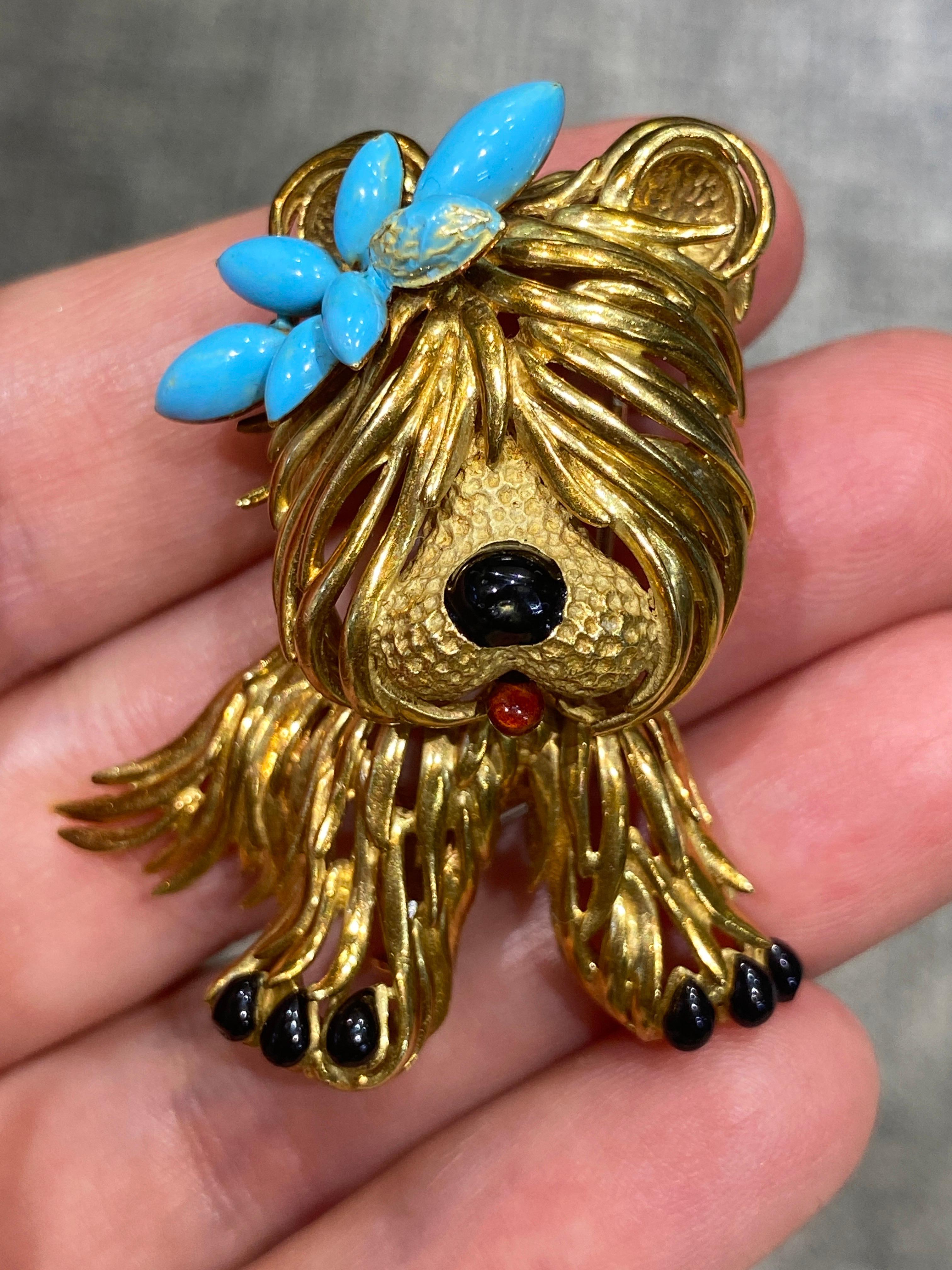 This charming Fred Paris 18 carat gold puppy brooch is a delightful piece. The blue bow in its hair and its red mouth are made of enamel while its nose and feet are made of onyx. The workmanship is quite remarkable.