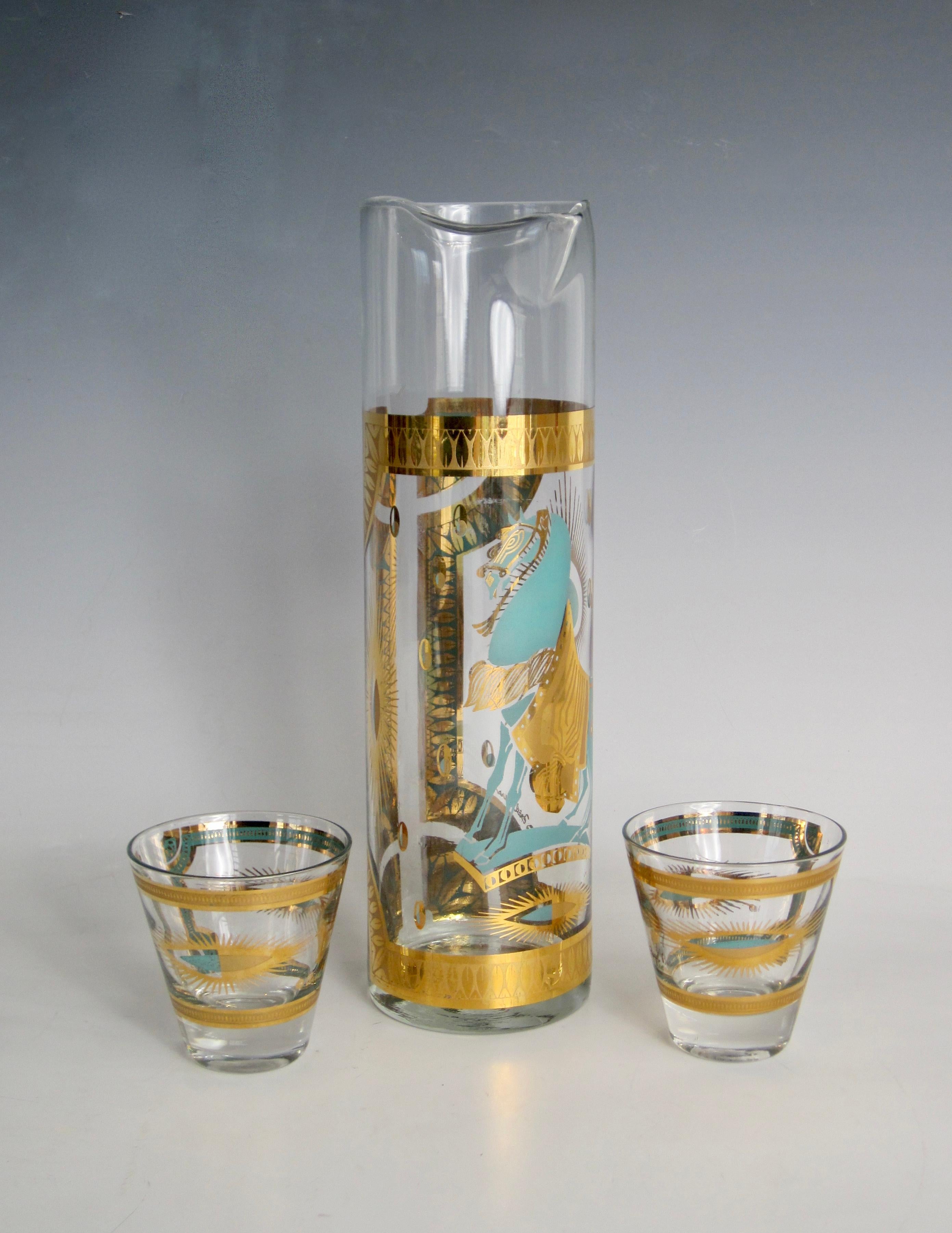 Three piece Fred Press barware set - cocktail pitcher and two rocks glasses-  with trojan horse and starbursts in teal and 22k gold.

As the chief designer and executive Vice President of Rubel & Company in New York City from the 1950-1980's, Fred