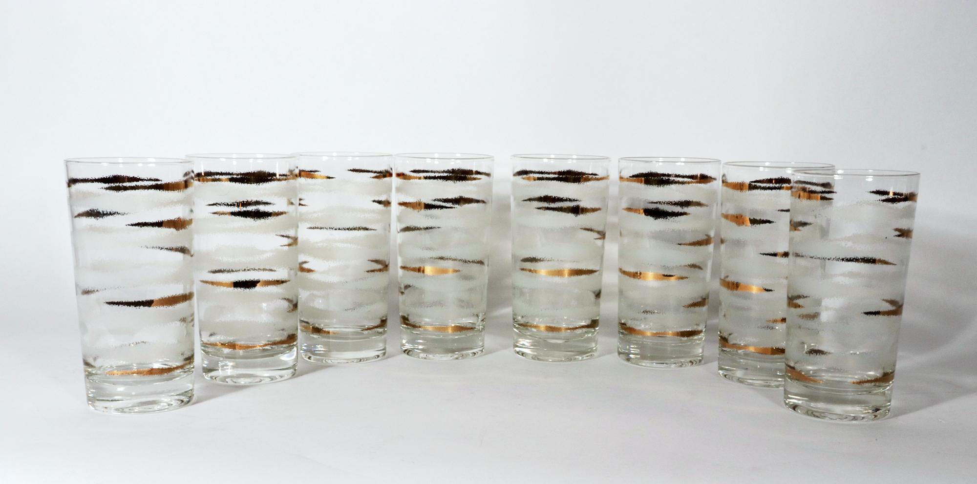 Fred Press Vintage High Ball Glasses,
A Set of eight.
1950s-60s.

The tall cylinrical glasses known as high ball or Tom Collins glasses are designed with bands of 22 k gold short stripes alternating with white cloud continuous bands.

Mark: @Fred