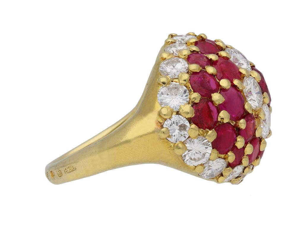 Fred, ruby and diamond cluster ring. Set with twenty three round old cut natural unenhanced rubies in open back grain settings with an approximate combined weight of 4.50 carats, further set with twenty four round brilliant cut diamonds in open back