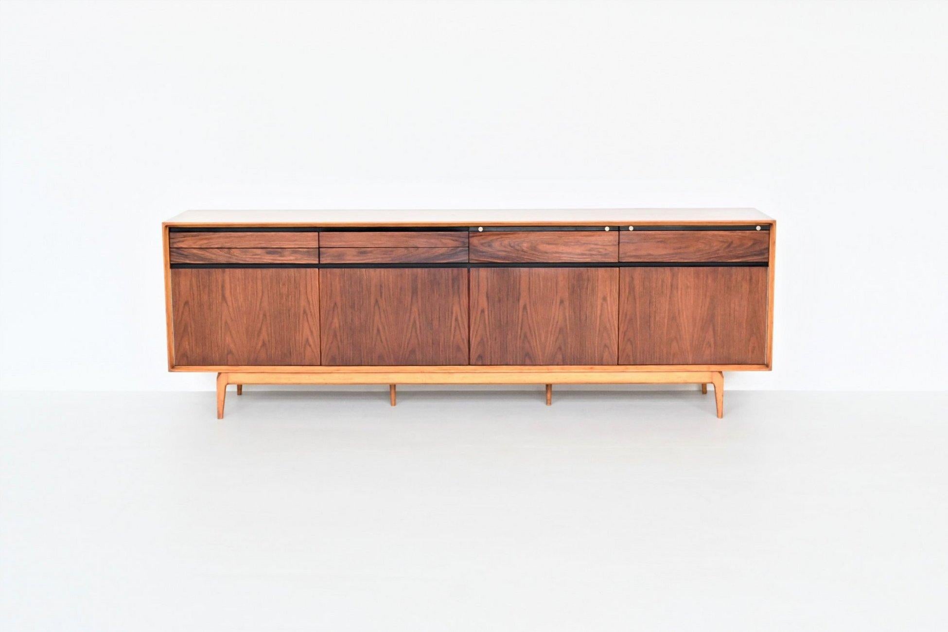 Beautiful and very rare sideboard model Madison designed by Fred Sandra and manufactured by De Coene, Belgium 1960. This well-crafted and heavy sideboard is produced in rosewood and walnut. It has a very nice and warm grain to the rosewood veneered