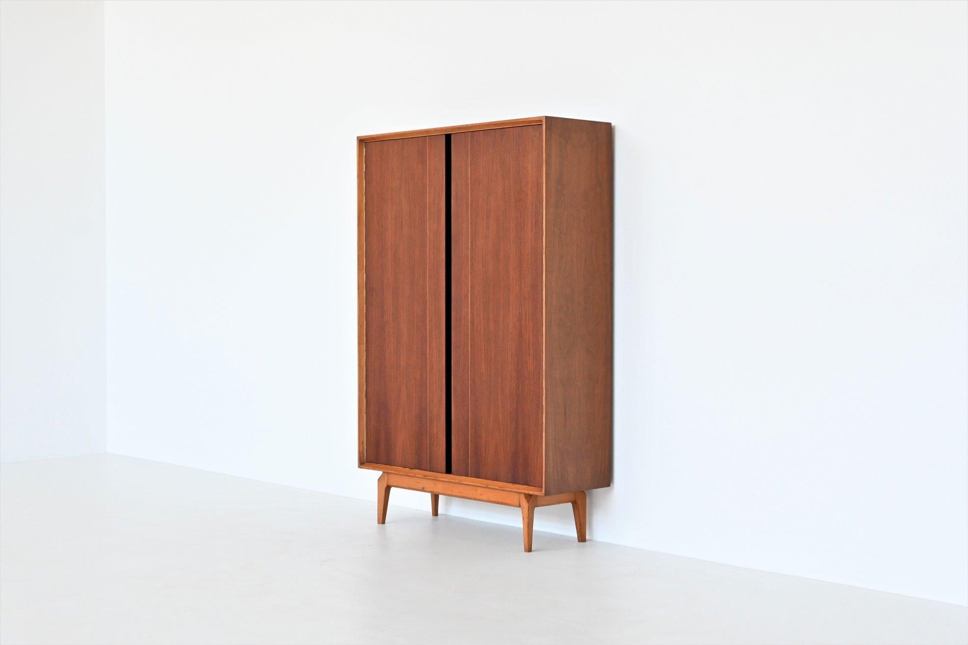 Beautiful and very rare high cabinet model Madison designed by Fred Sandra and manufactured by De Coene, Belgium 1960. This well-crafted cabinet is produced in rosewood and walnut. It has a very nice and warm grain to the rosewood veneered doors.