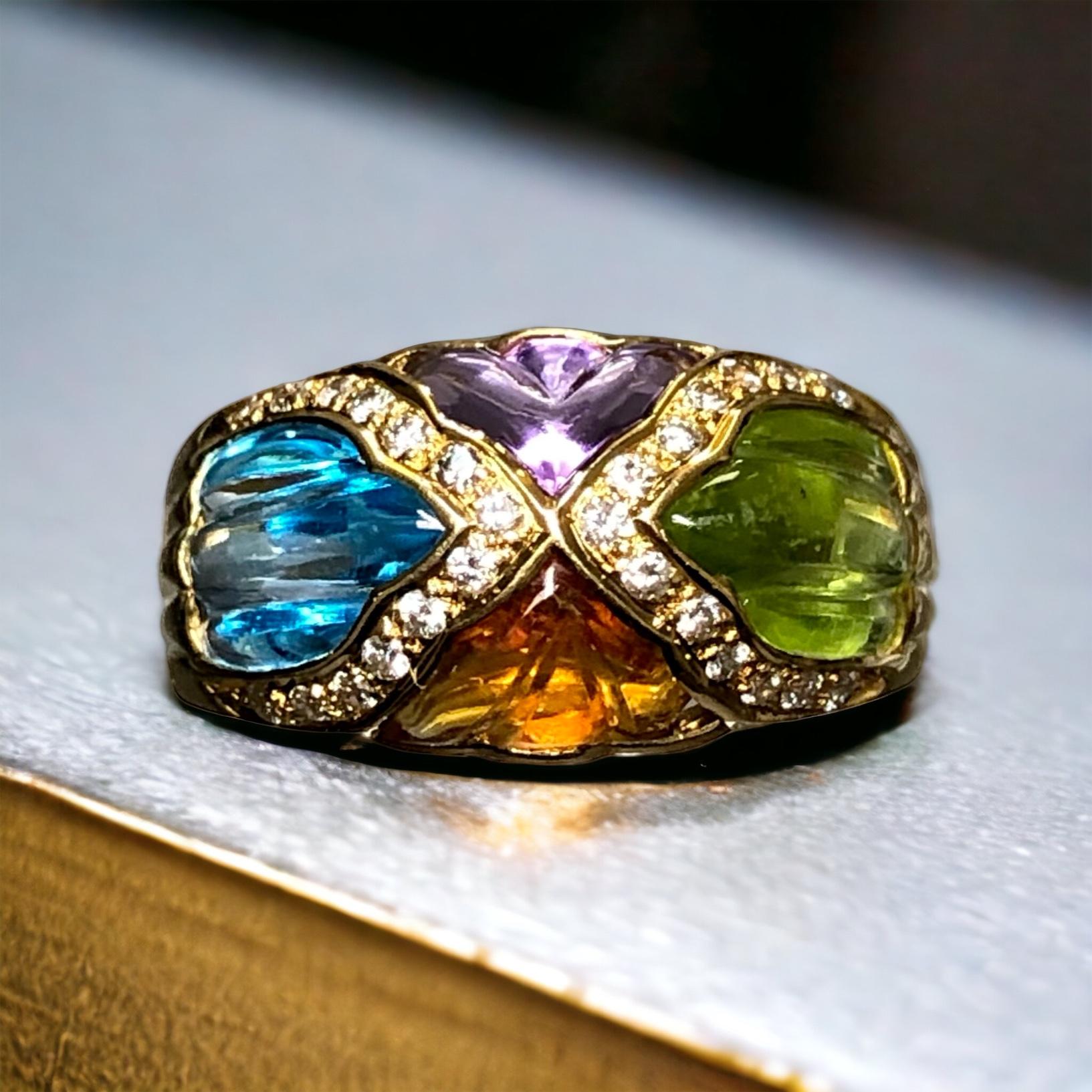 A beautiful ring done by English maker, Fred E Ullman of London c. 1993. It has been hand crafted in 18K yellow gold and flush set with natural carved/buff top amethyst, topaz, citrine and tourmaline as well as approximately .26cttw in G-I Vs