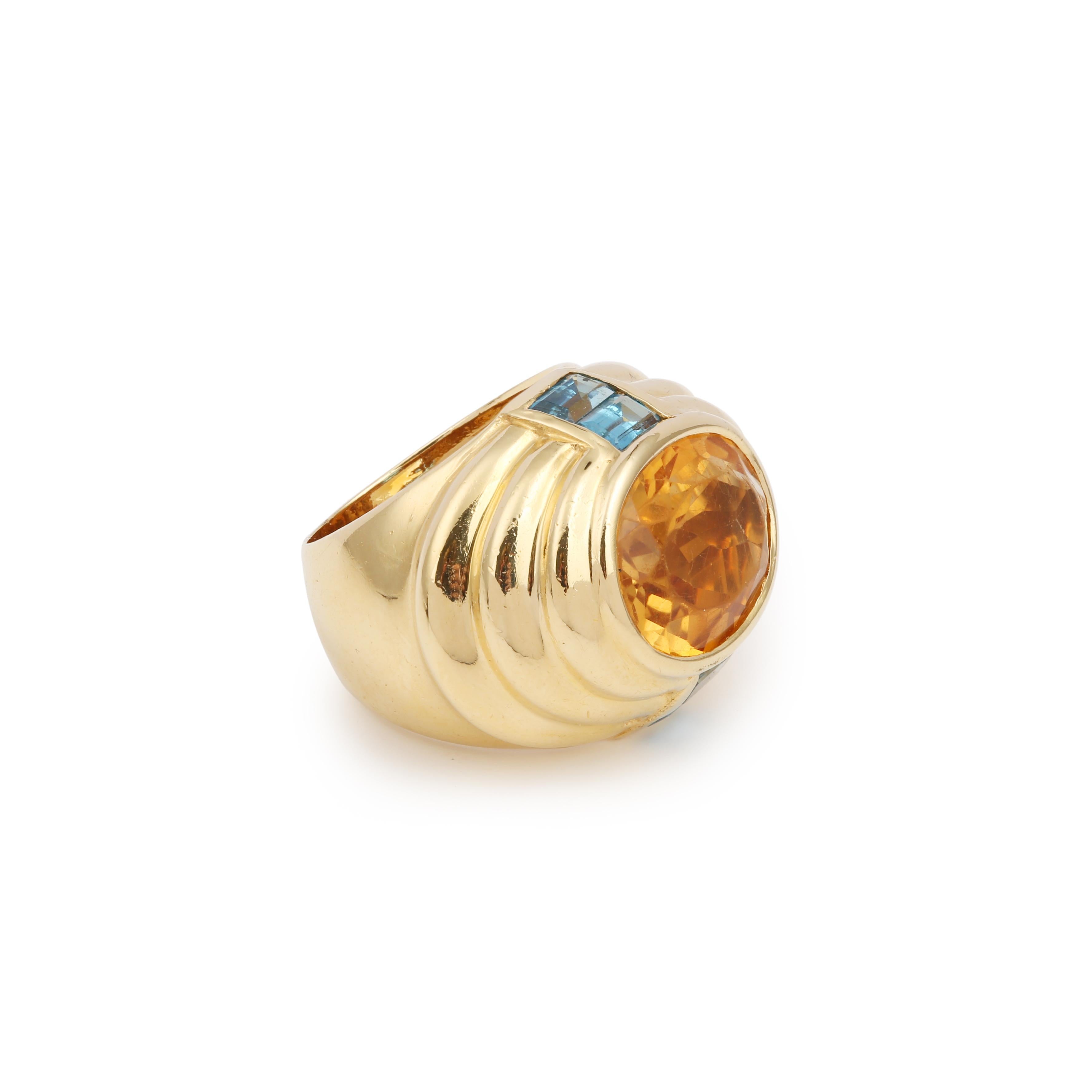 Vintage Fred cocktail ring with gadroons, centred on an oval-cut citrine and set on either side with four rectangular topazes.

Signed Fred and hallmarked 750 (Signature slightly faded due to an old cut)

Estimated citrine weight: 6 carats

Slight