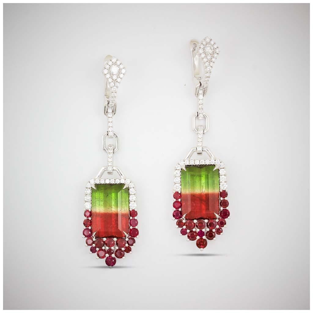 One-of-a-kind Frederic Sage bi-color Watermelon Tourmaline drop earrings with ruby and diamond accents with diamond bale set in 18 karat white gold

Total Bi-color Tourmaline weight: 15.78 ct
Total ruby count: 34
Total ruby weight: 2.33 ct
Total