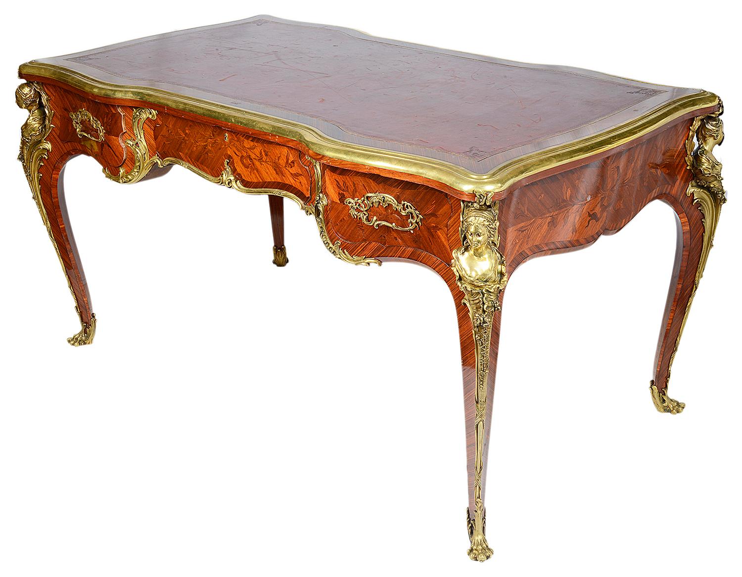 A fine quality 19th century marquetry inlaid French Louis XVI style bureau plat. Having an inset tooled leather top, an ormolu moulding around, three oak lined frieze drawers, with the locks stamped; Schmit, Paris. Dummy drawers to the reverse.
The