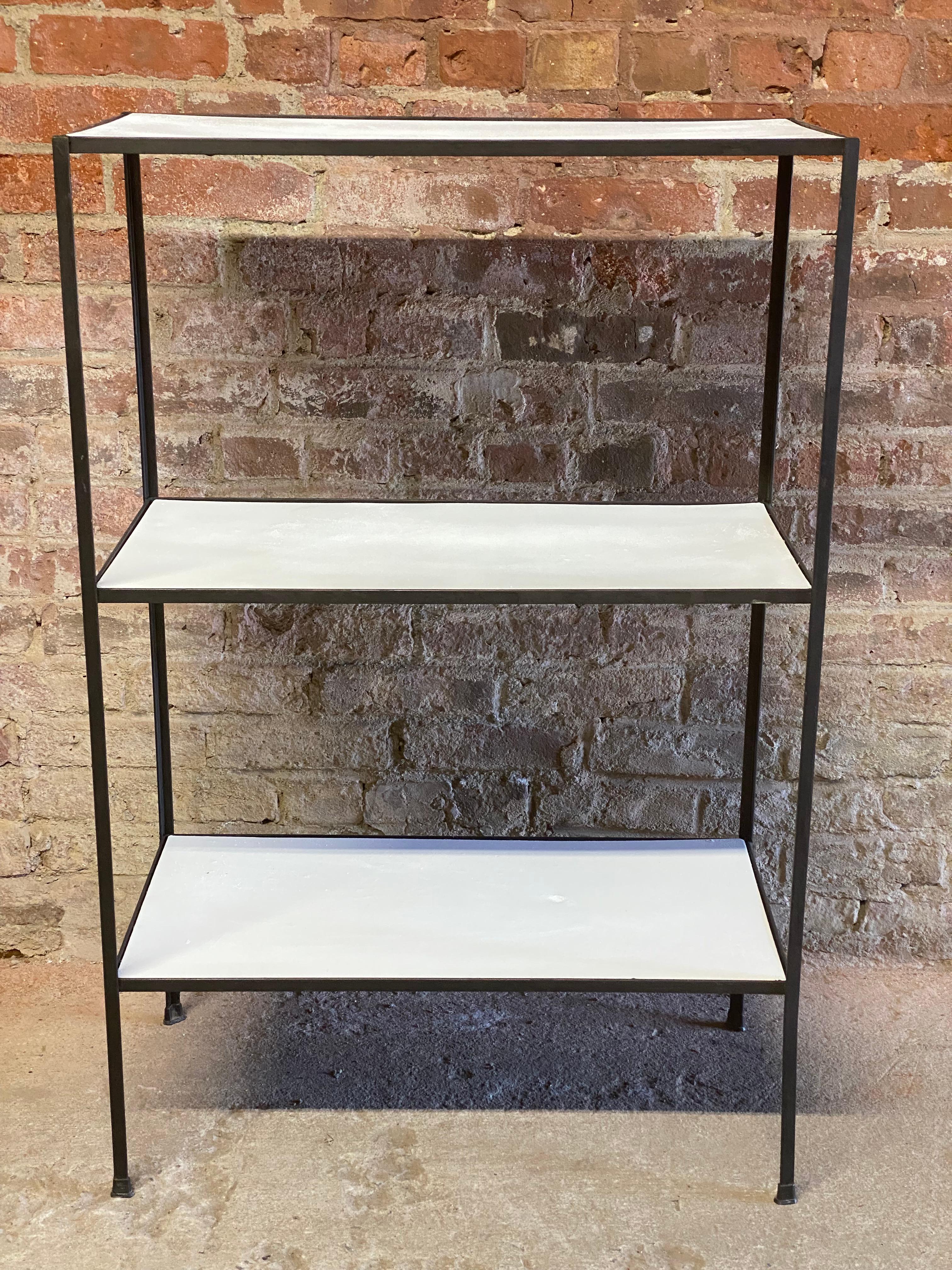 Iron and masonite three shelf unit designed by Frederick Weinberg. Angle iron construction with the original masonite shelves. Circa 1950-60. Good overall condition. The masonite shelves have been overpainted and have some divots, dings, swelling
