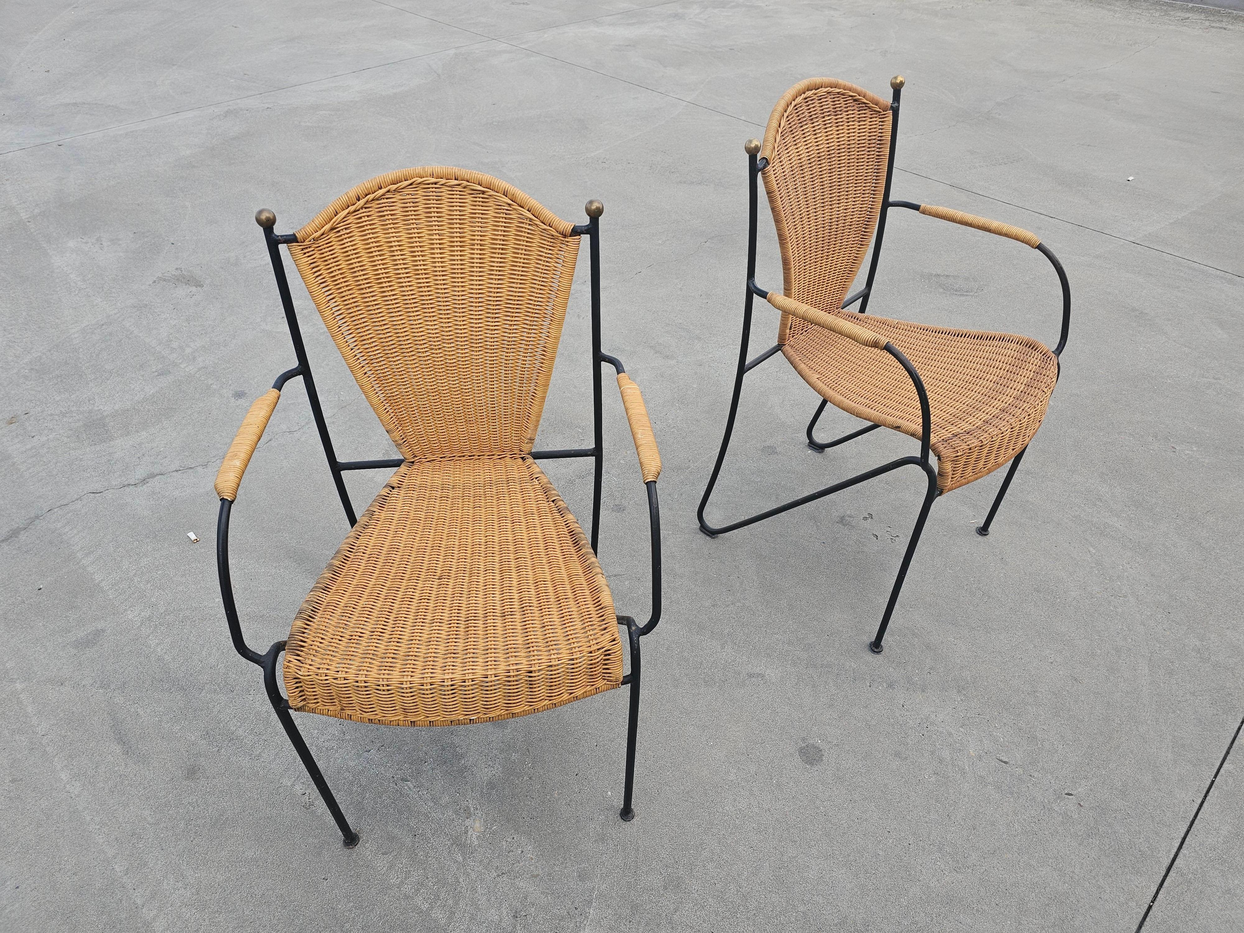 In this listing you will find a set of Mid-Century Modern chairs designed by Frederic Weinberg, the renowned US designer. Chairs are made of wrought iron and wicker, with brass details on the backrests, which makes them stand out. 

Chairs are in