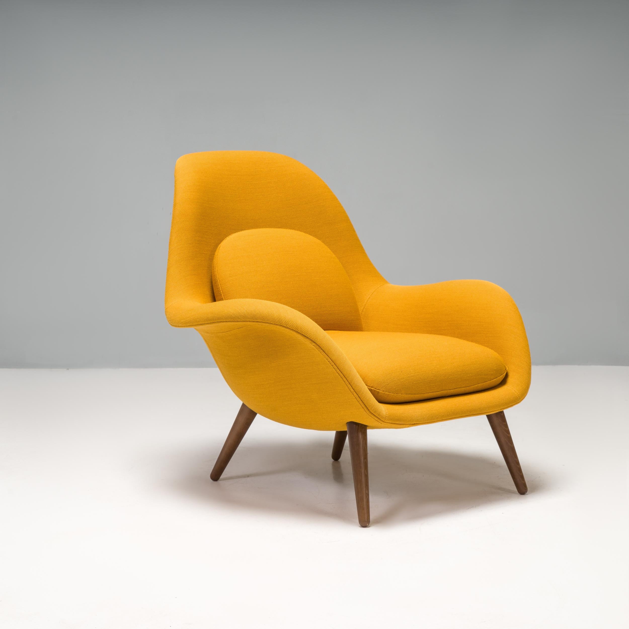 Designed by Space Copenhagen for Danish furniture manufacturer Fredericia, this Swoon armchair was made in 2021.

Featuring a lacquered walnut frame, the chair has a sculptural silhouette with a high curved back, giving a contemporary update to the