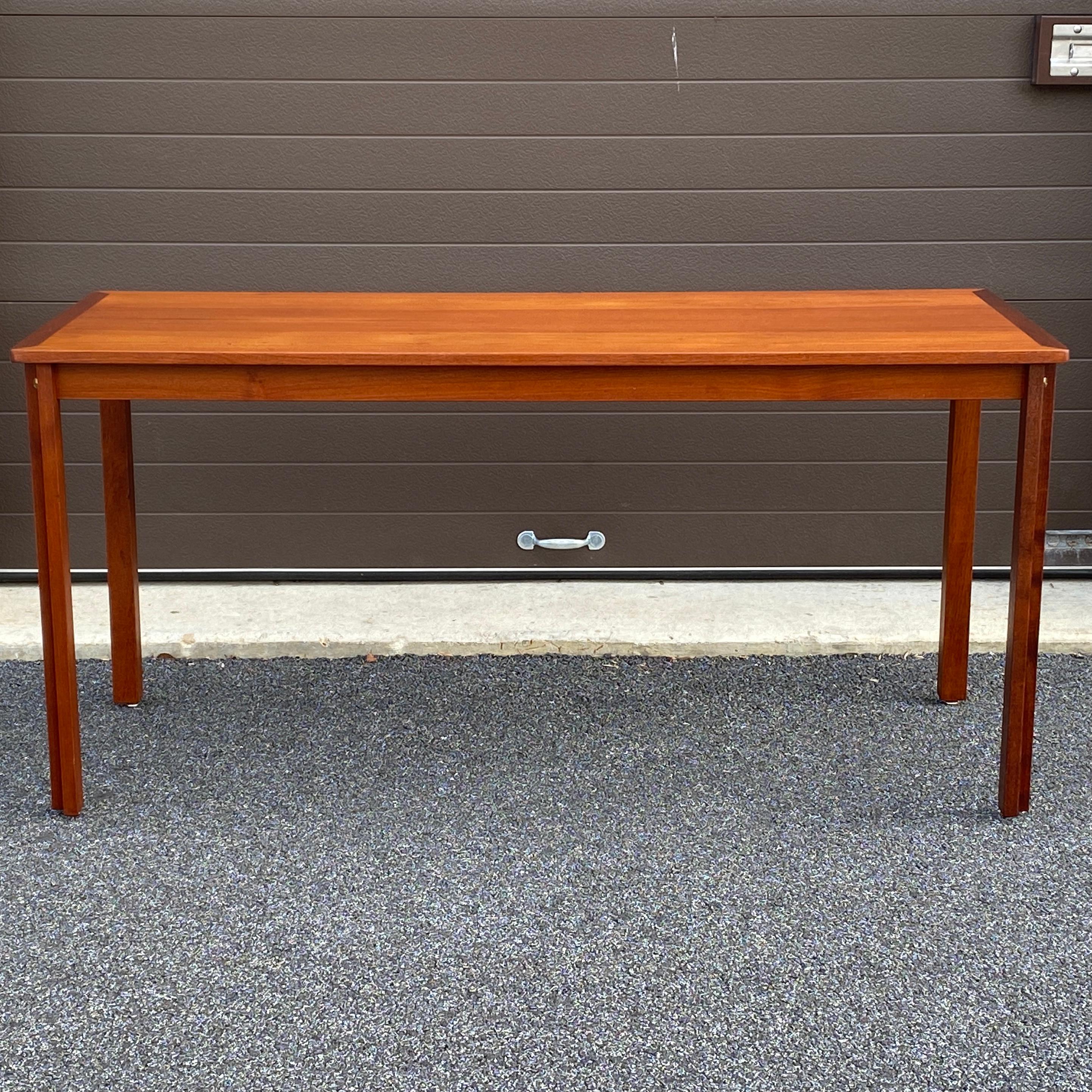 A rare teak writing desk designed by Borge Mogensen circa 1958 featuring L-shaped table legs with exposed brass screw. Stamped underneath.

28.375” table height with the metal feet
25.25” knee clearance.