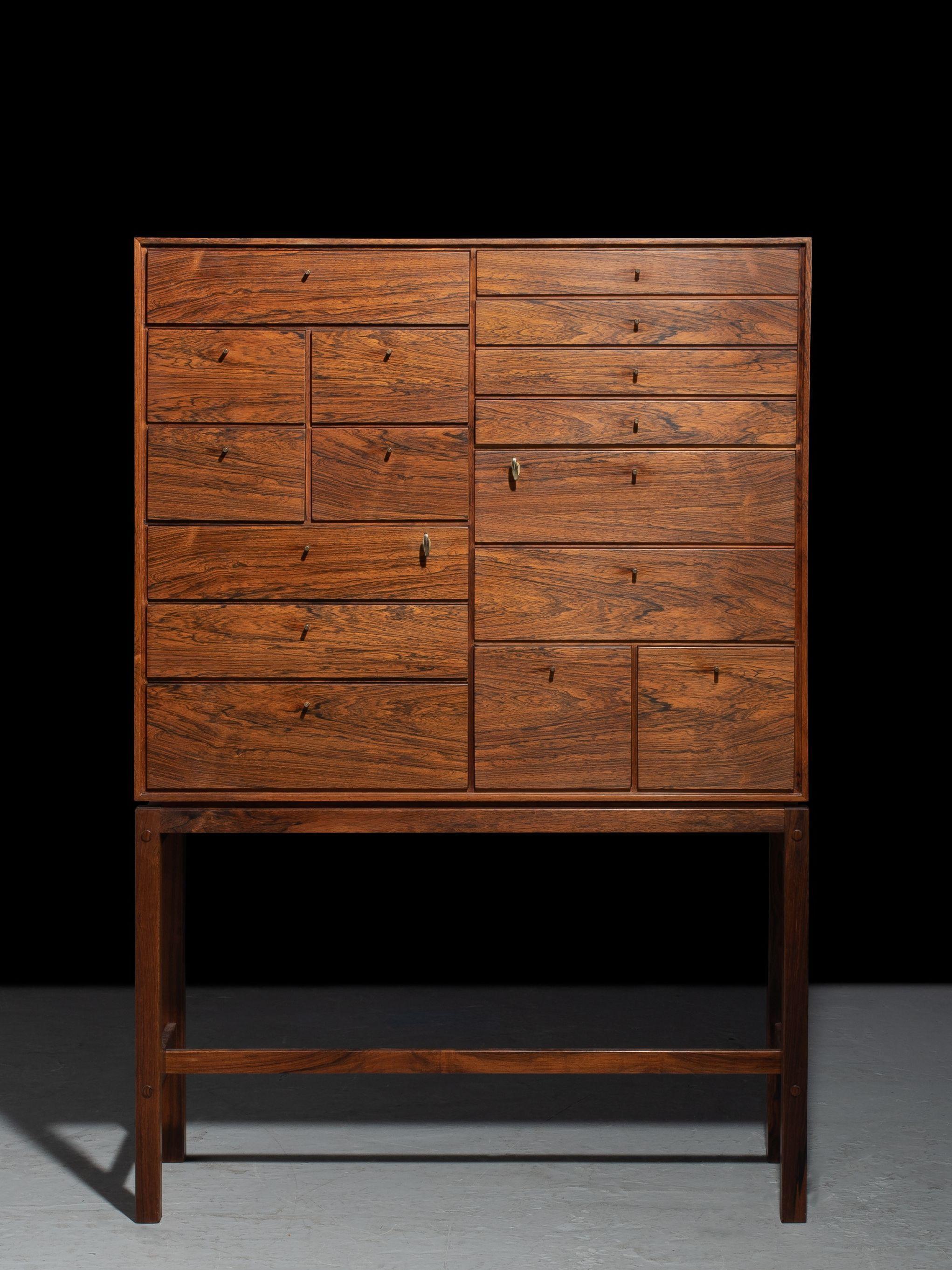 Cabinet in rosewood with 16 drawers and brass fittings made and designed by Fredericia Mobelfabrik in the 1960s. Two drawers has lock and comes with key.