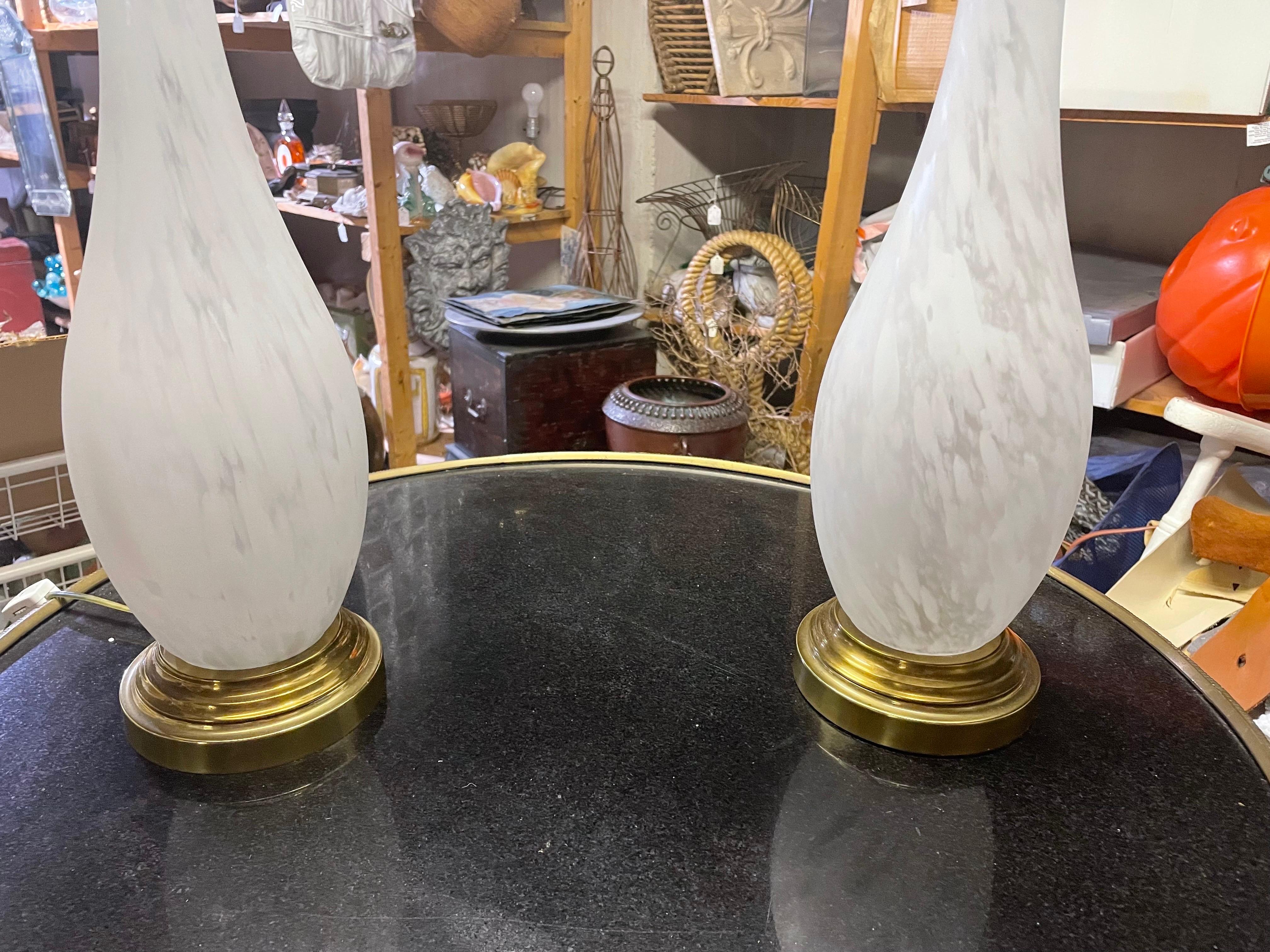 This is a lovely vintage pair of white Art glass and brass lamps by Frederick Cooper 
The lamps are 18 inc tall to socket but 28 tall to finial.