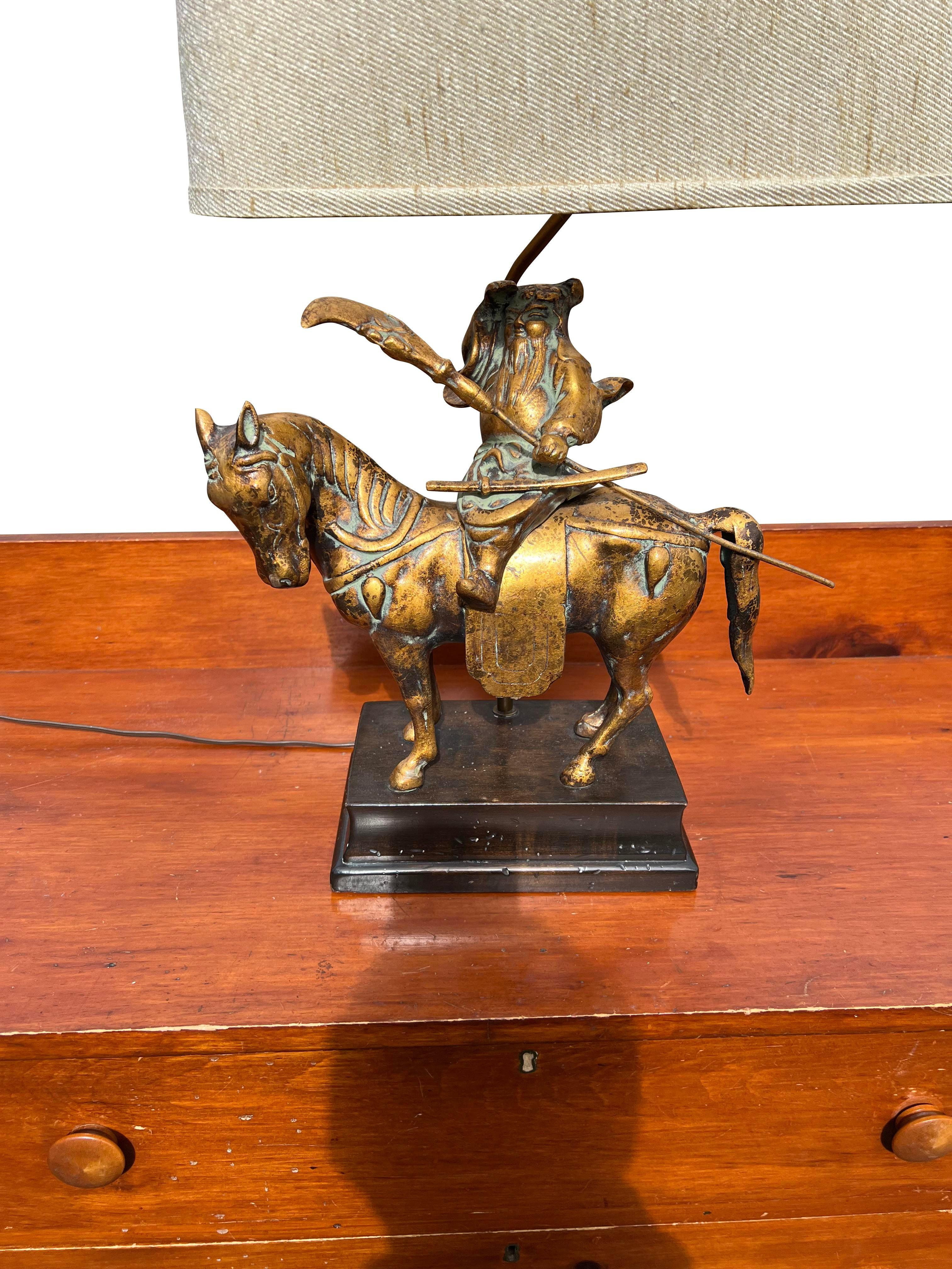 Frederick Cooper Asian Style Brass Table Lamp.

Add a touch of exotic elegance to your home with this stunning Frederick Cooper Asian Style Brass Table Lamp. This unique piece features a detailed brass sculpture of a samurai on horseback, making it