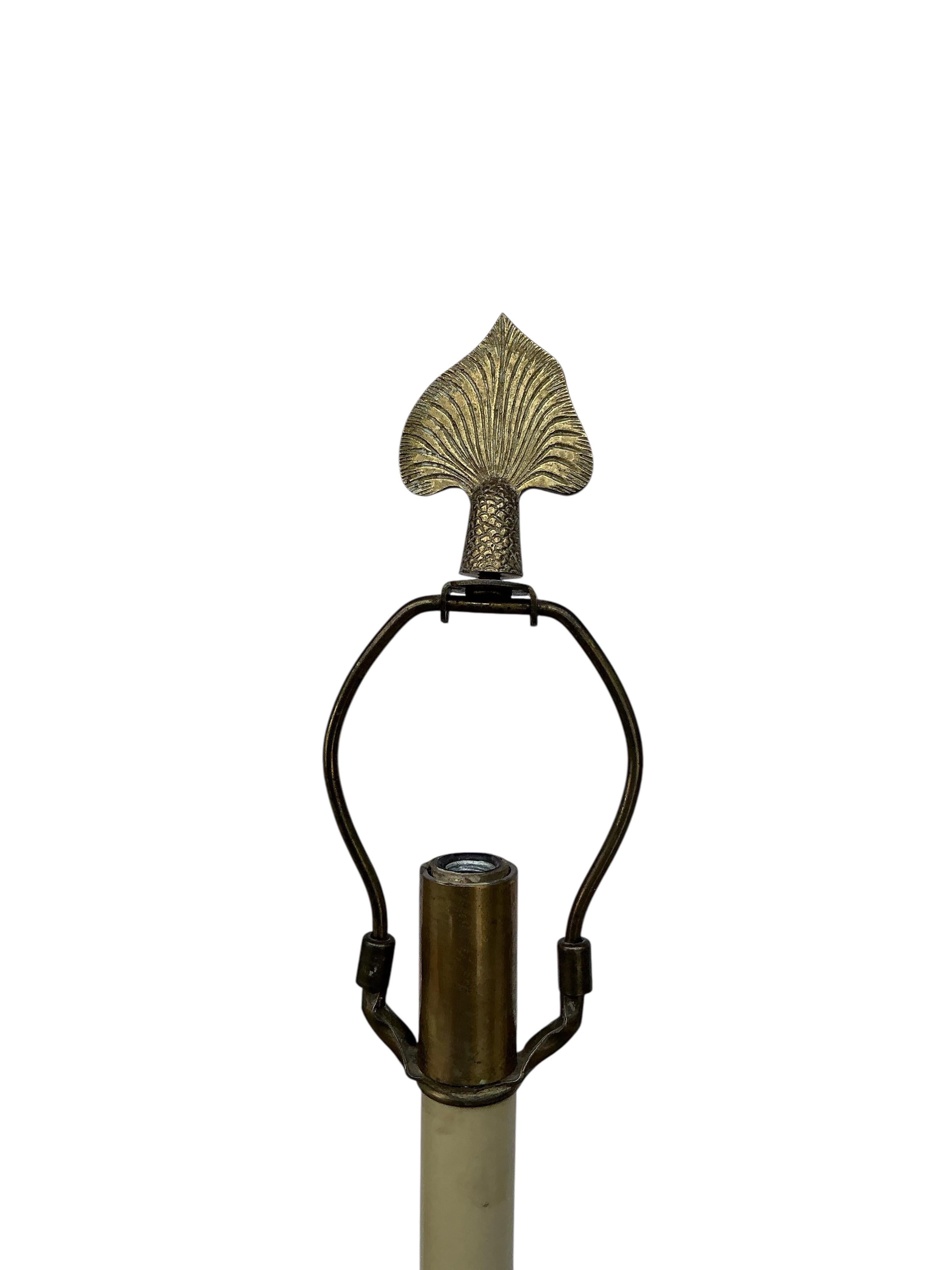 This is a pair of neo-classical style buffet or table lamps designed by Frederick Cooper. They are solid brass. The dolphin base is a 9” triangle. The pleated linen shades show some wear. The height to the socket is 31.25 inches. The shade is 14” in