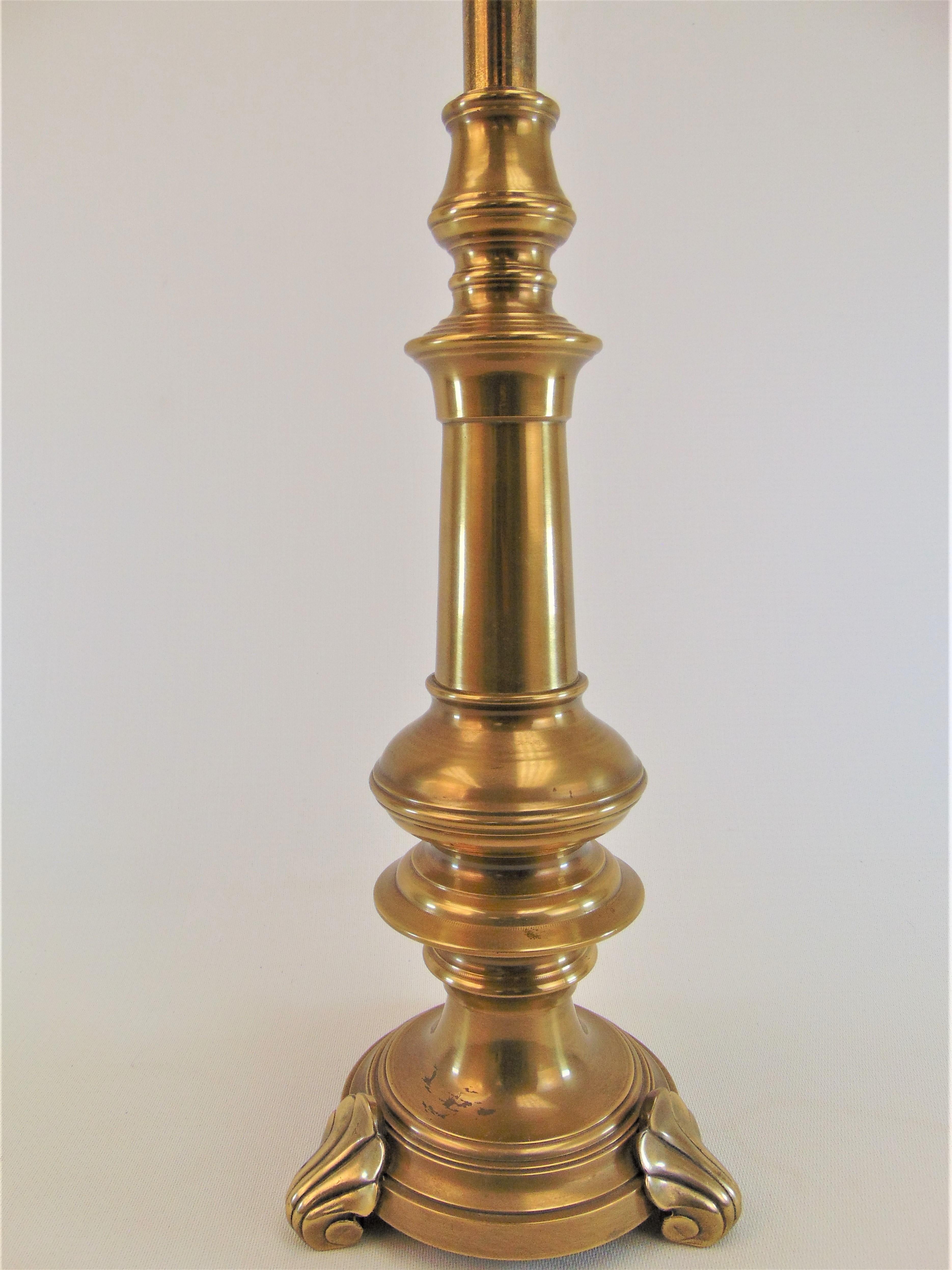 Classic heavy brass table lamp by Frederick Cooper. It has three brass shell feet and a candlestick style body mimicking gorgeous turned wood. It is a timeless lamp and would look great in almost any style room.
Dimensions:
Base width 7