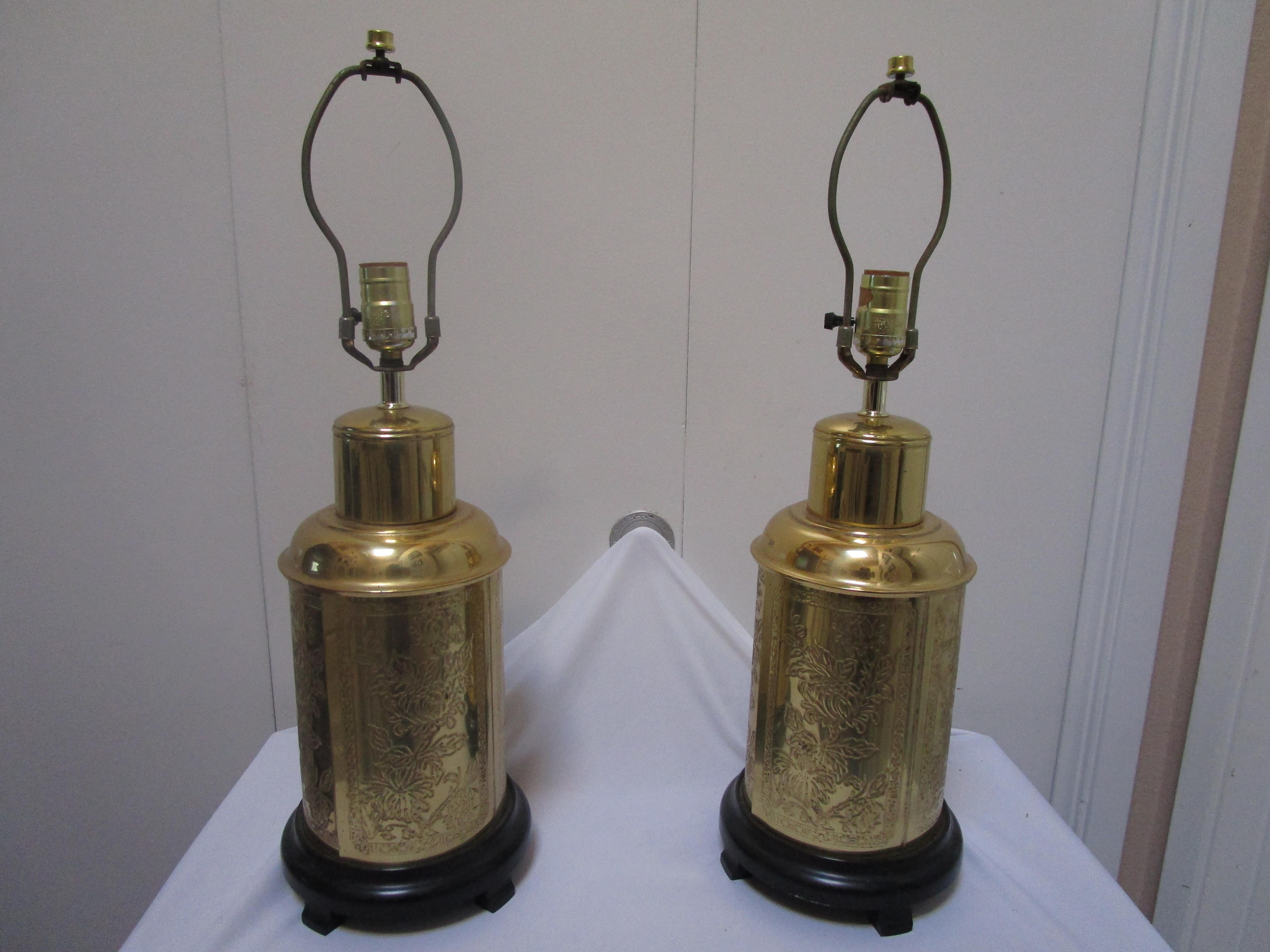 Fredrick Cooper's beautiful styling on brass with etched designs on the surface of this pair of Hollywood Regency lamps create a lighting standout. They will enhance many design settings in an office or home. The lamps are themed as tea caddy shapes