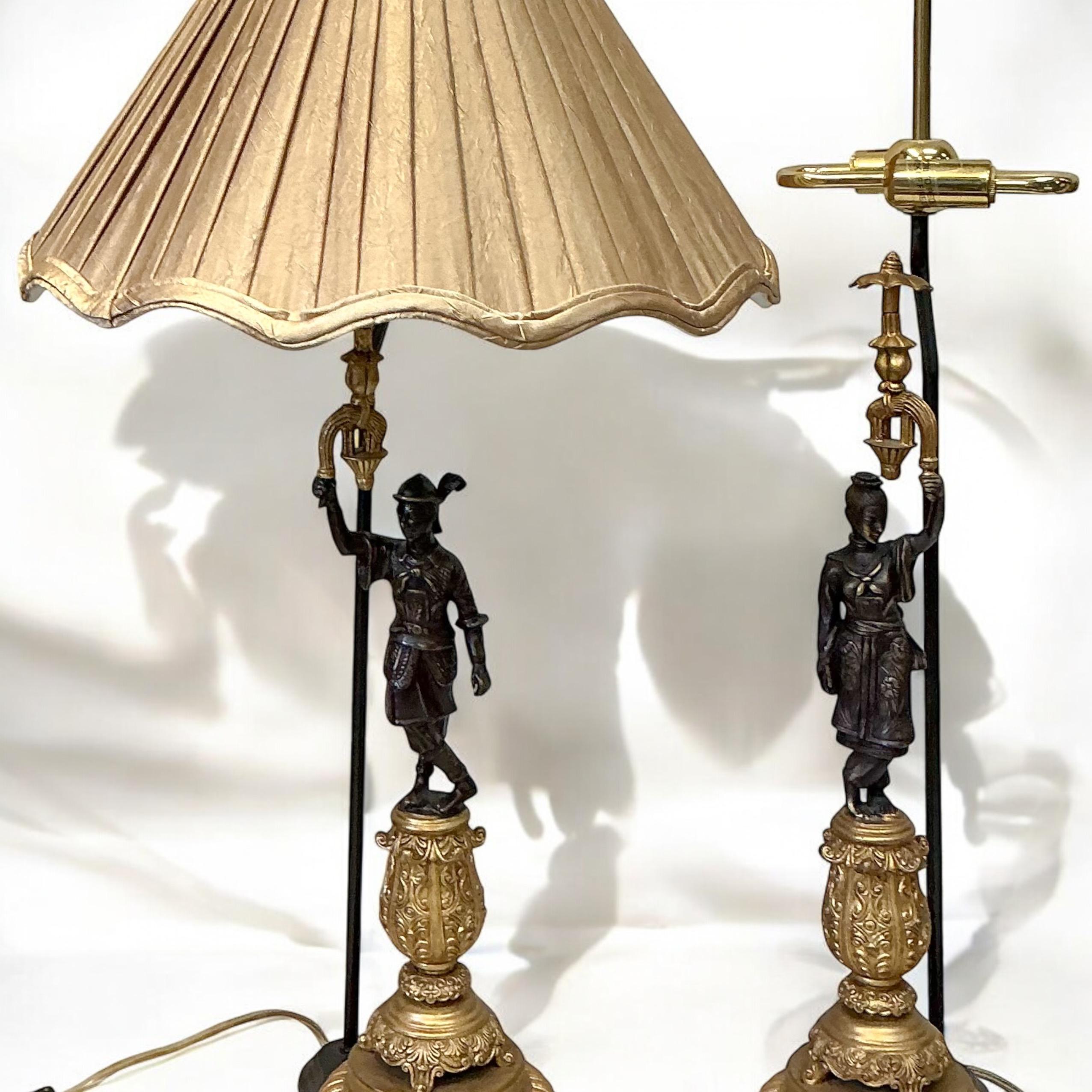 This is a regency style gilt bronze Asian male and female chinoiserie table lamps by Frederick Cooper. They do include the original silk shades, and they are marked. They are in very good condition. The height to the finial is 29”. To the socket, it