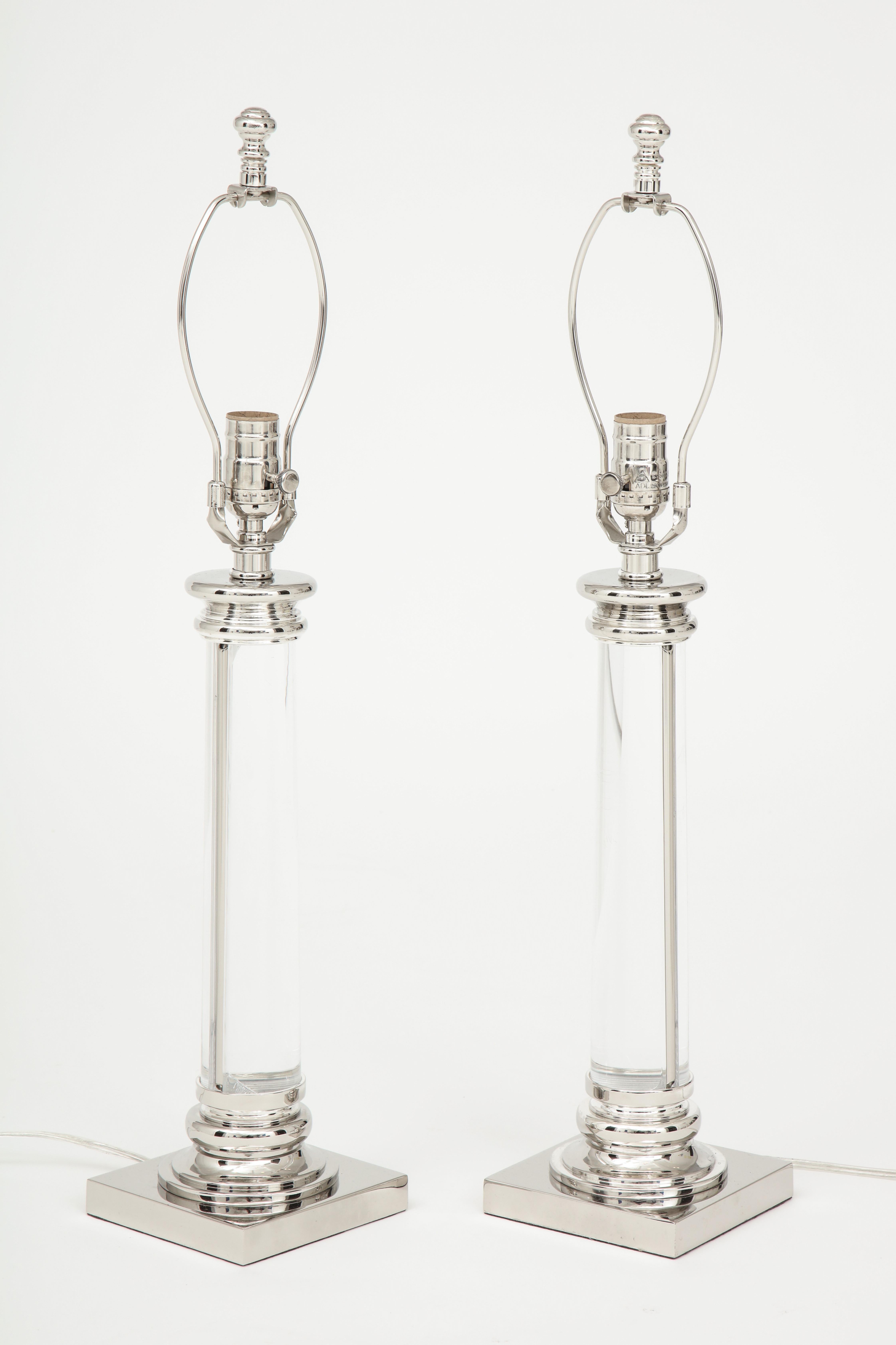Pair of modernist glass column lamps with polished nickel base and decorative cap. Rewired for use in the USA, each using 1 Edison type bulb, 100W max.