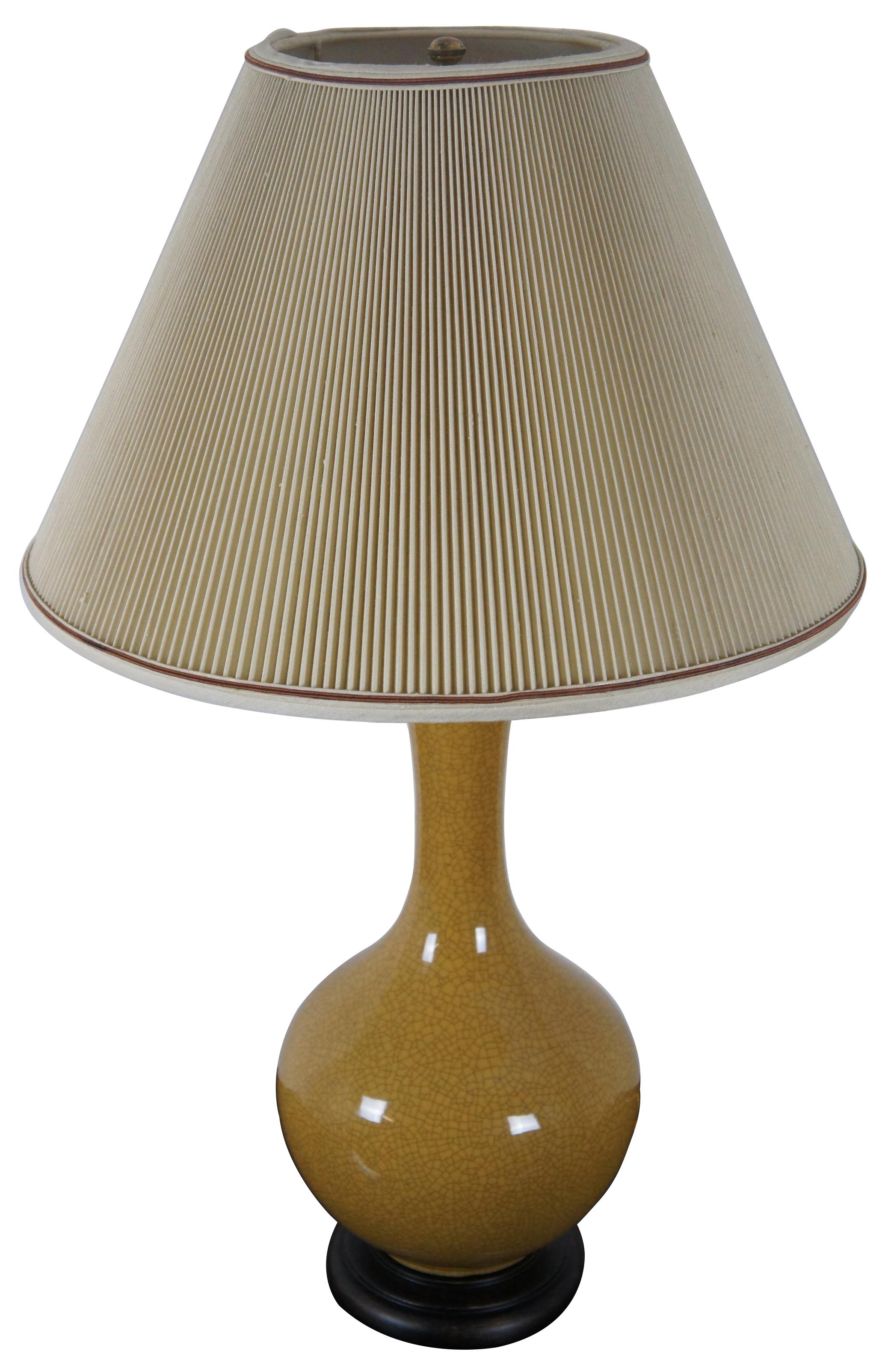 Circa 1970s ceramic table lamp by Frederick Cooper. Features a mustard yellow glaze with a dark crackle finish and wooden base.

Measures: 8.5” x 21.5” / shade 17.5” x 11.25” / height to top of finial 29.25” (diameter x height).