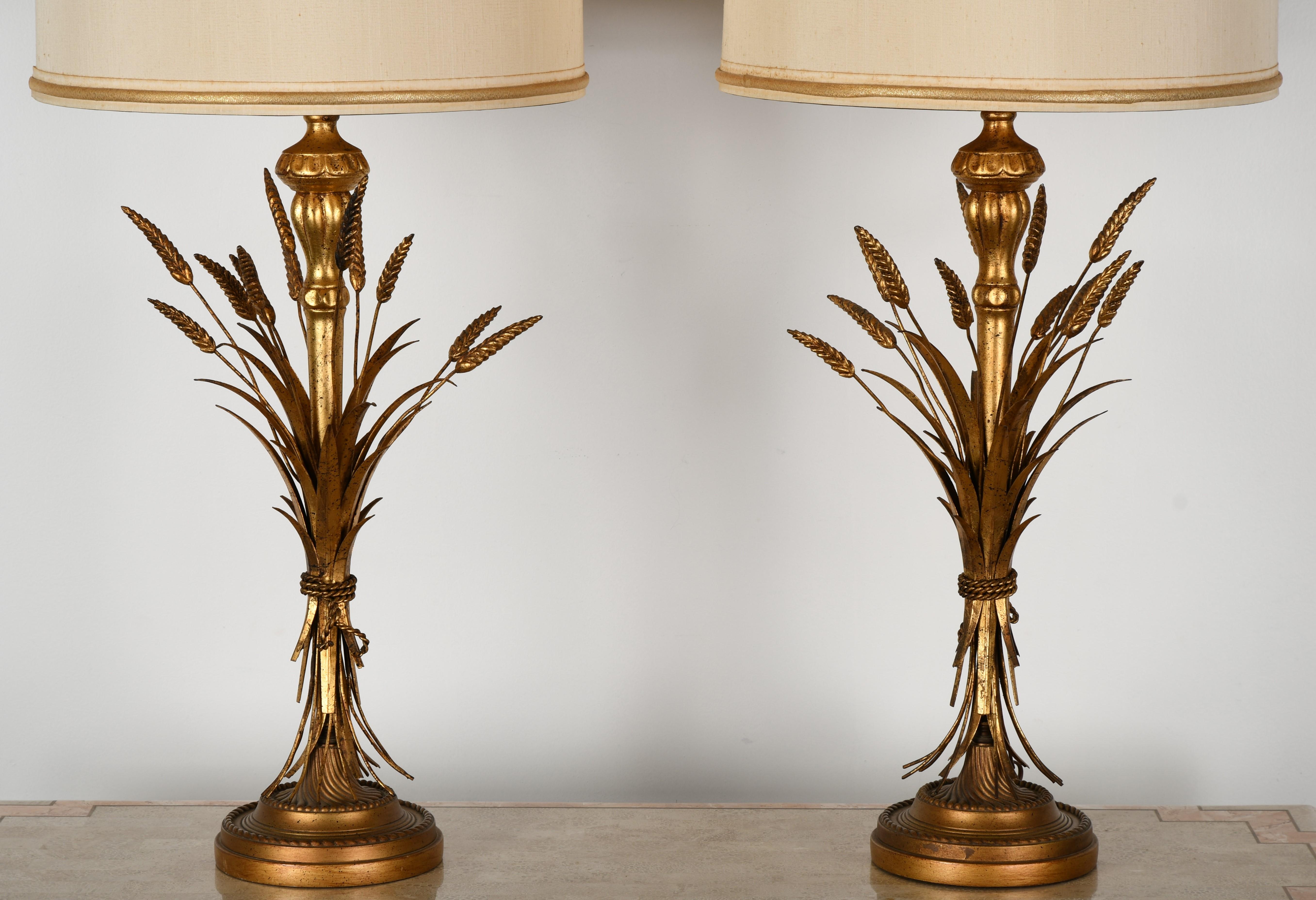 A beautiful pair of decorative table lamps in a wheat sheaf motif by Frederick Cooper. Made of metal and giltwood. In very good condition with age appropriate wear. Vintage shades not included unless desired. Retain their original wiring.