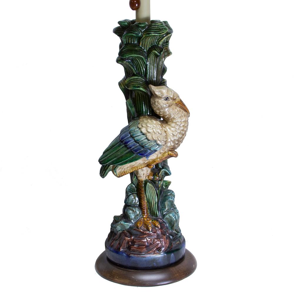 This beautiful pair of Frederick cooper lamps features a pair of colorful storks. Seated within a cluster of lush green reeds, each bird is slightly different and has blue-accented plumage. These lamps retain their original hallmarked woven rattan