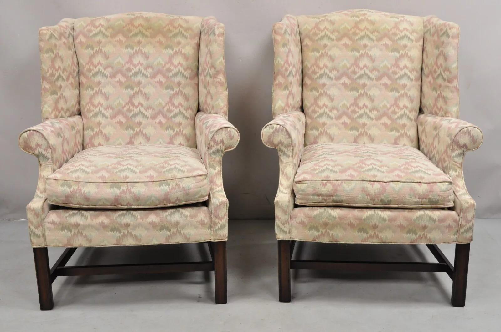 Vintage Frederick Edward Georgian Style Wingback Lounge Arm Chairs with Cherry Wood Legs - a Pair. Made in America with Pink, Green, and Beige Upholstery. Circa Late 20th Century. Measurements: 41