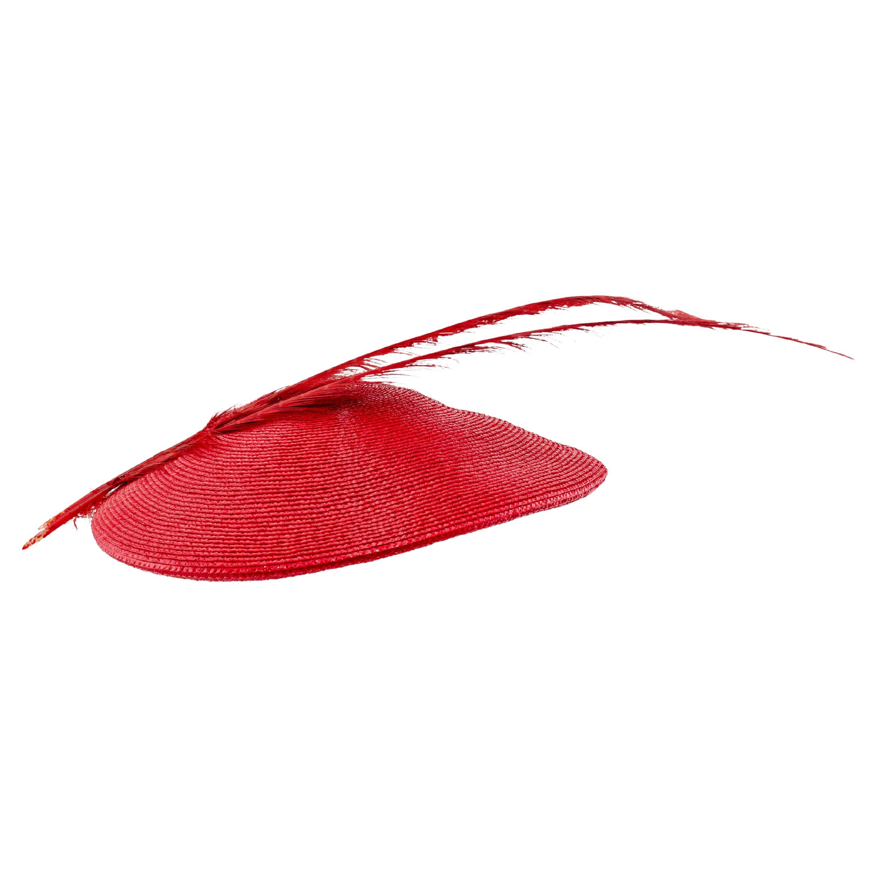 Frederick Fox, milliner to the royal family in the UK complete with Royal Warrant by Appointment to Her Majesty Queen Elizabeth II created this eye catching masterpiece in red straw and feather to be worn for a special occasion. Elegant in its