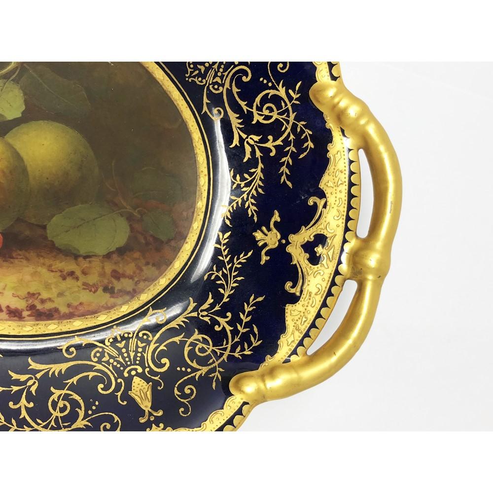 Coalport dessert service painted by Fred Howard each with a still life of different fruits and their foliage, each signed 'F. HOWARD', reserved against a mazarine blue ground enriched with gilt scroll foliage between gilt borders with raised