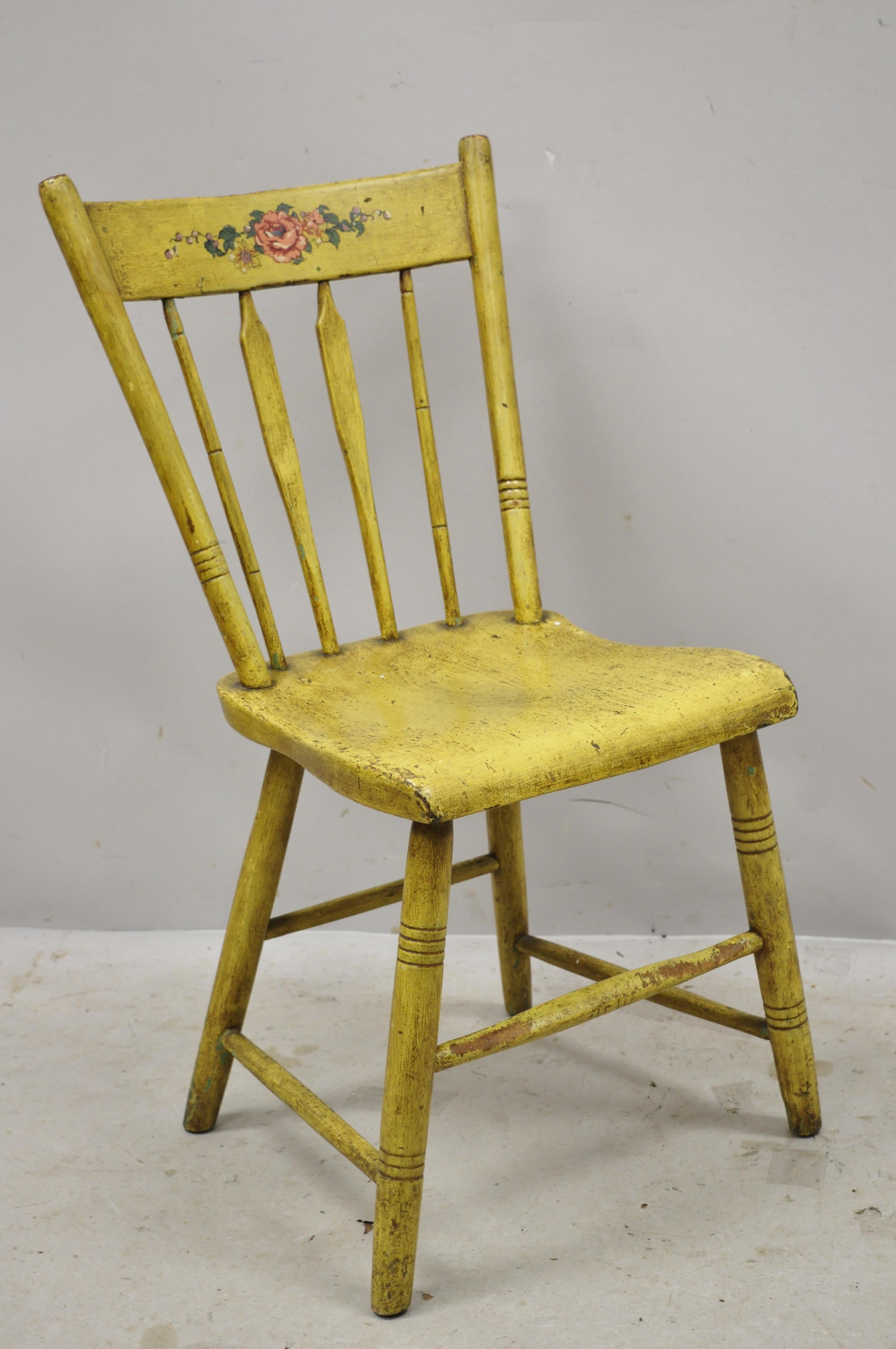 Antique Frederick Loeser & Co yellow American primitive Hitchcock style painted side chair (A). Item features floral painted backrest, spindle back, carved stretcher base, remarkable patina, solid wood frames, yellow distressed finish, very nice