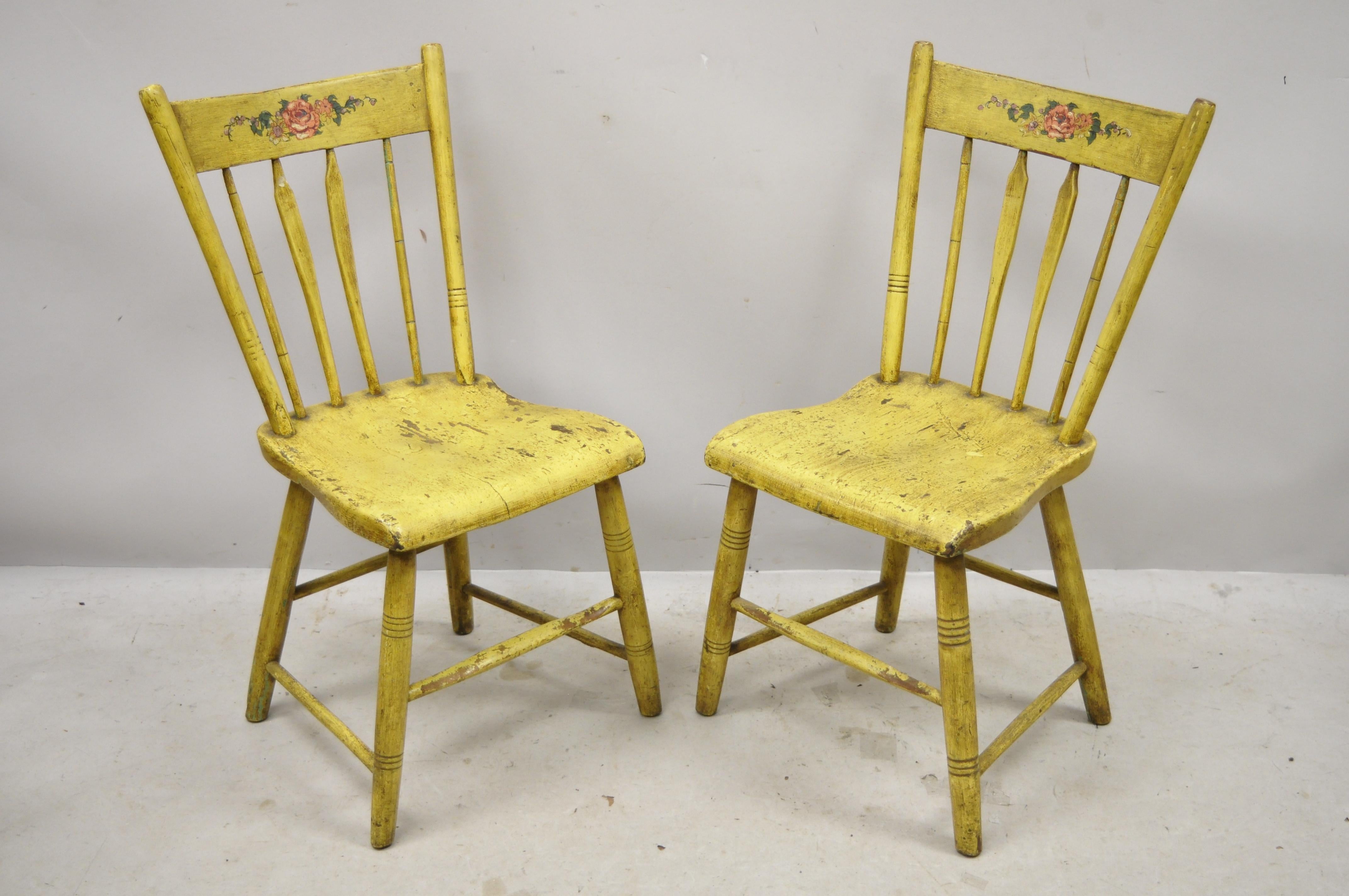 Antique Frederick Loeser & Co Yellow American Primitive Hitchcock style painted side chairs - a pair (A). Item features floral painted backrest, spindle back, carved stretcher base, remarkable patina, solid wood frames, yellow distressed finish,
