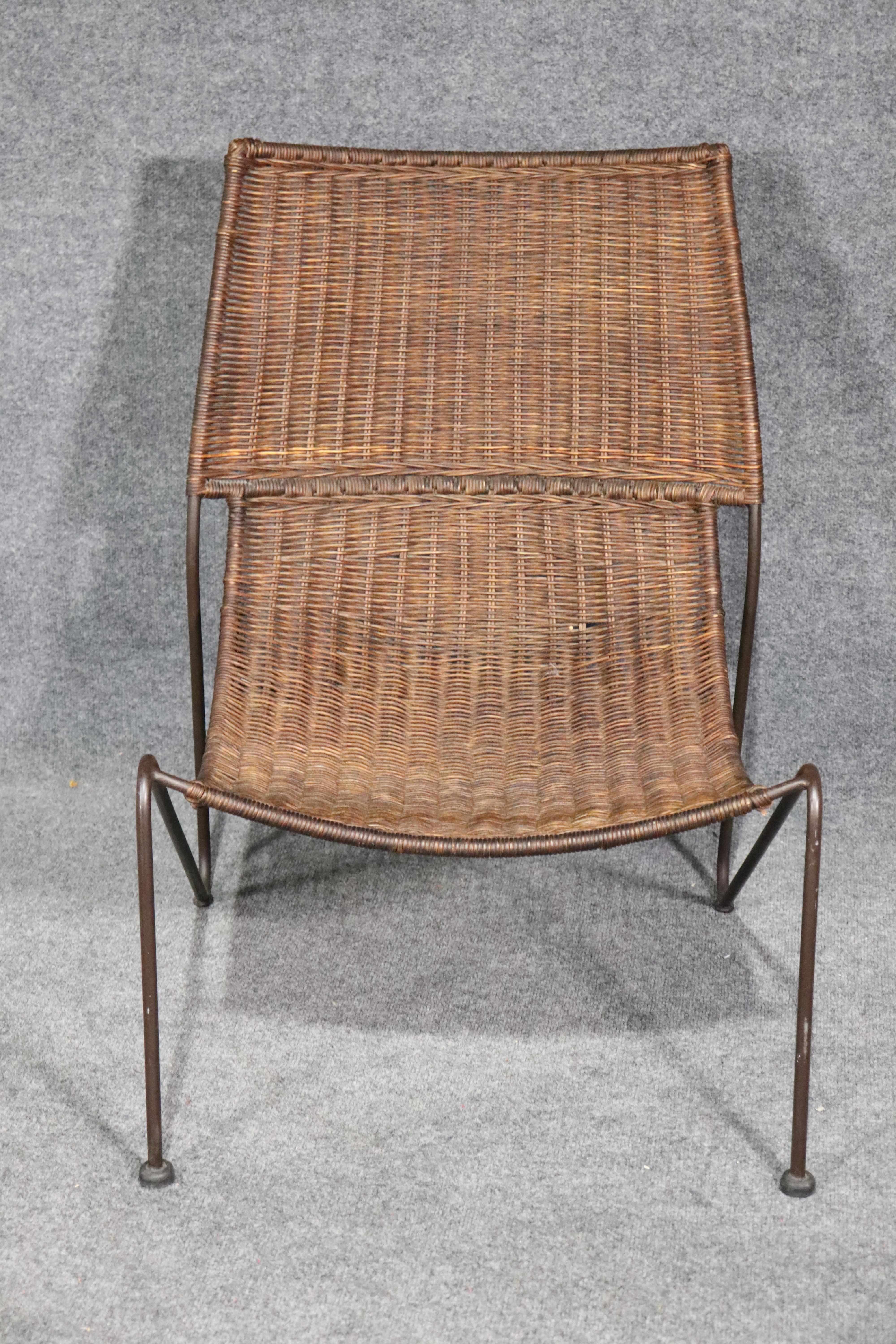 Single lounge chair for indoor or outdoor use. Designed by Frederick Weinberg with woven wicker seat and back on a sturdy iron frame.
Please confirm location.