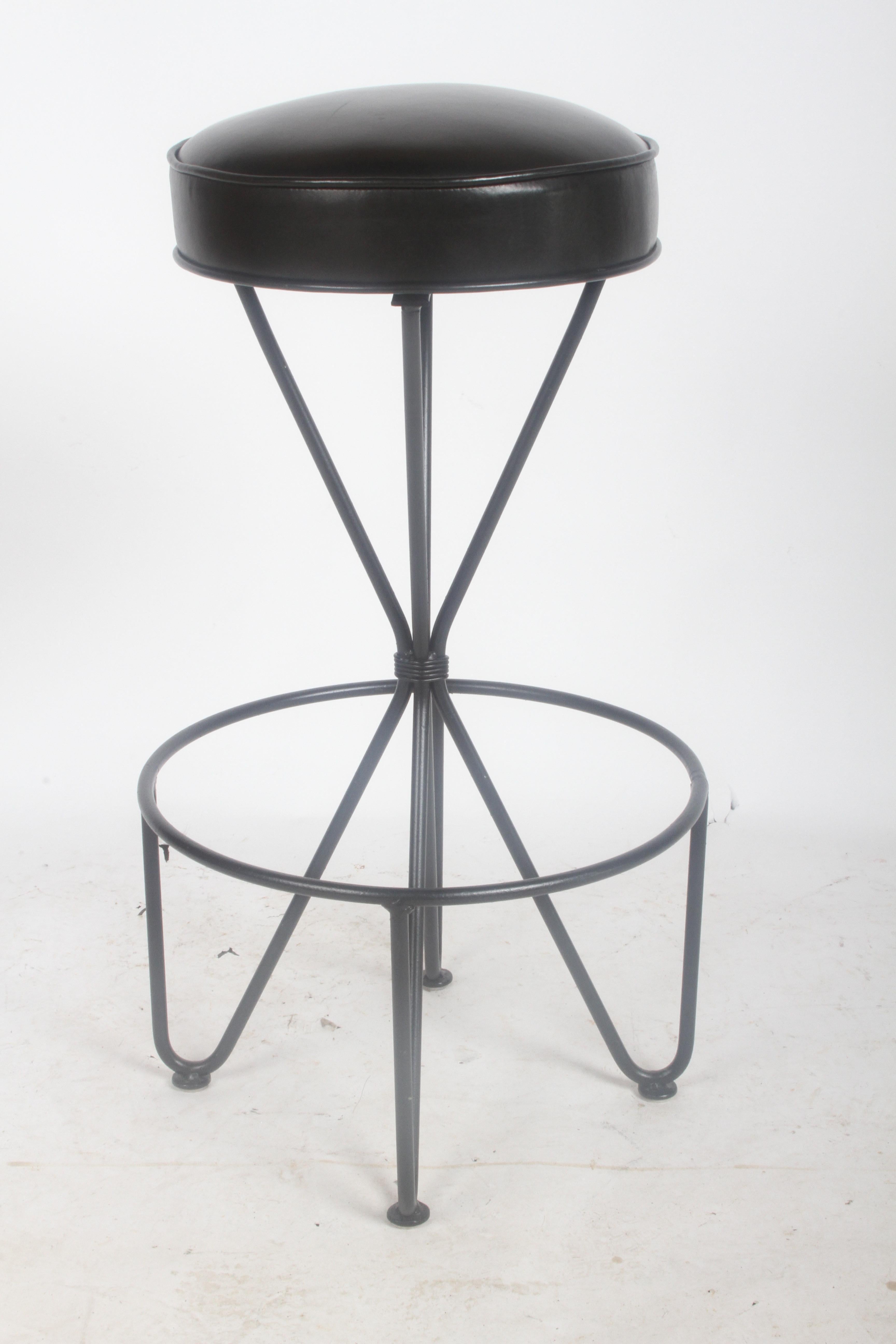 Single Frederick Weinberg circa 1950s swivel bar stool, refinished wrought iron base and black graphite leather seat. Light use, restored 4 years ago. Seat is 14