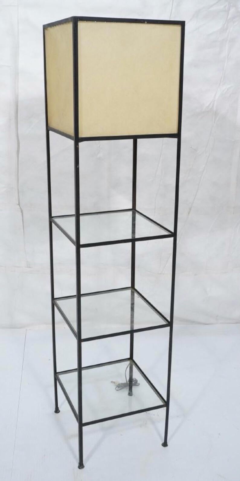 Modern iron floor lamp by Frederick Weinberg. Normal wear to metal as glass as photographed. Three-glass shelves with original shade at top.