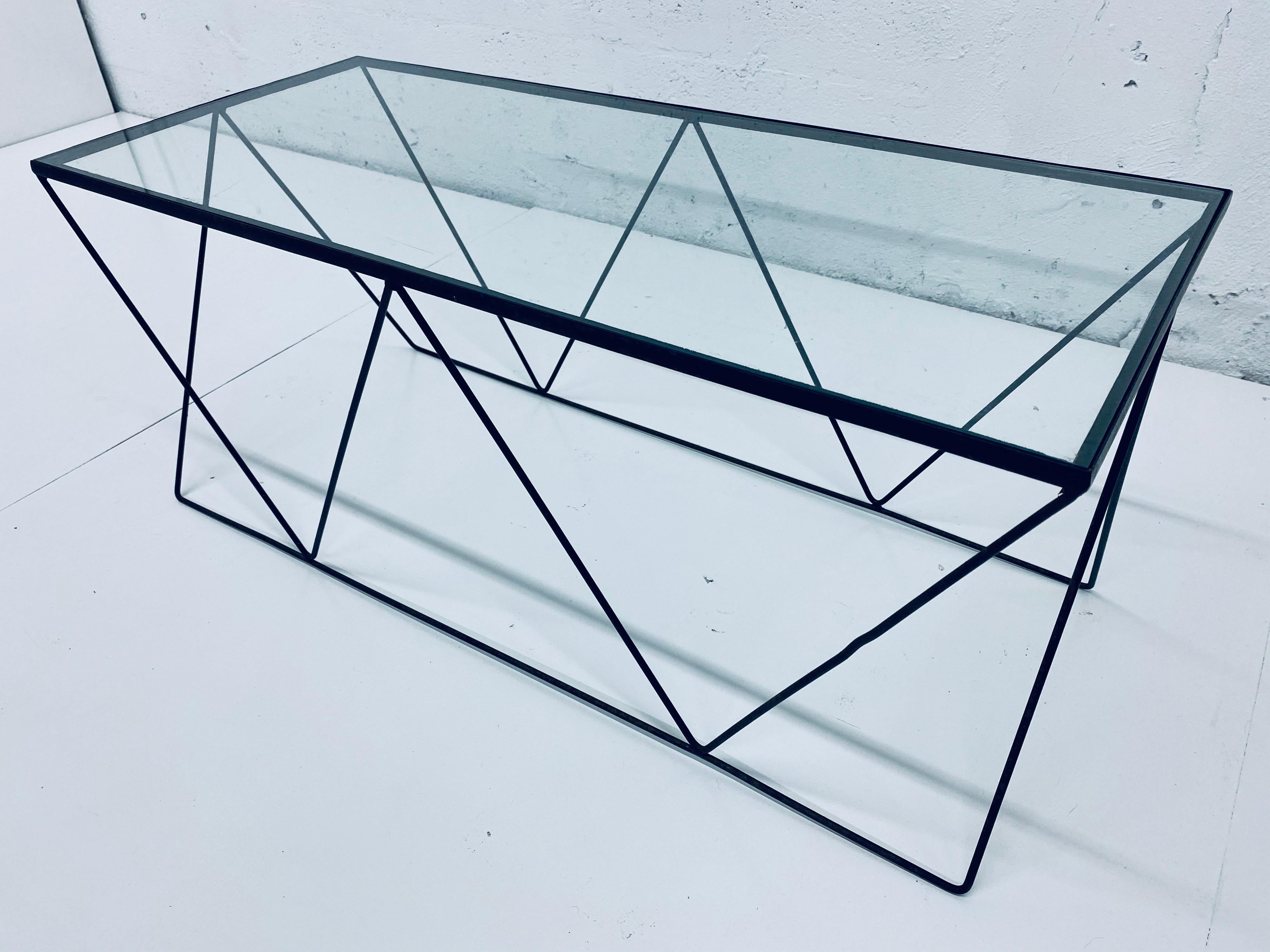 Styled after Frederick Weinberg / Arthur Umanoff, this petite coffee table is made of a wire frame with black lacquer and comes with the glass top. Original from the 1950s.