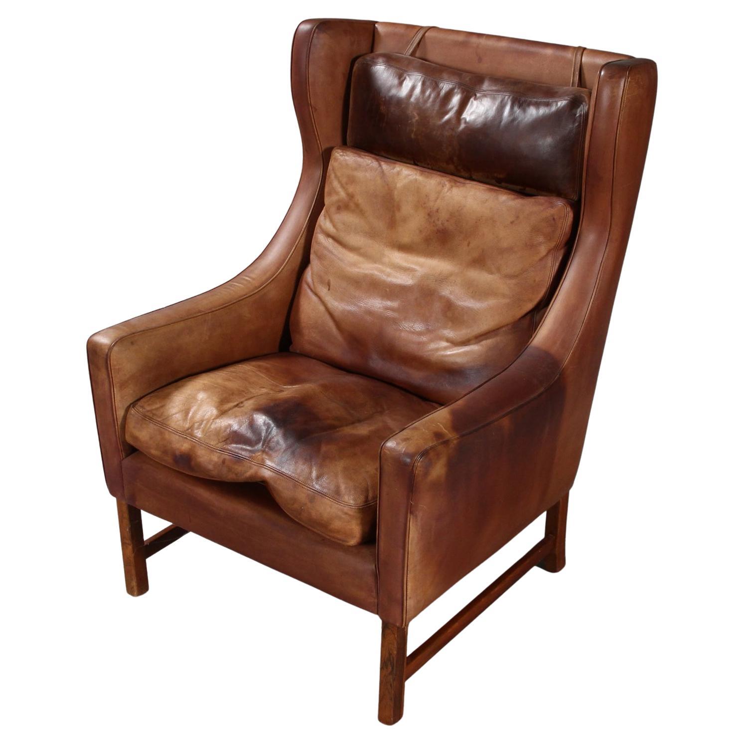 Frederik A. Kayser Wingback Chair Upholstered in Cognac-Ccolored Leather For Sale