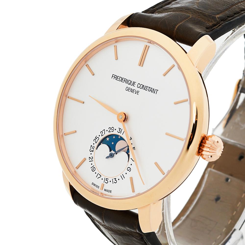 This authentic Frederique Constant wristwatch delivers a luxurious look with style. It has a leather bracelet and a rose gold-plated stainless steel case. The round dial is set with stick hour markers, two hands, and a moonphase at 6 o'clock. A