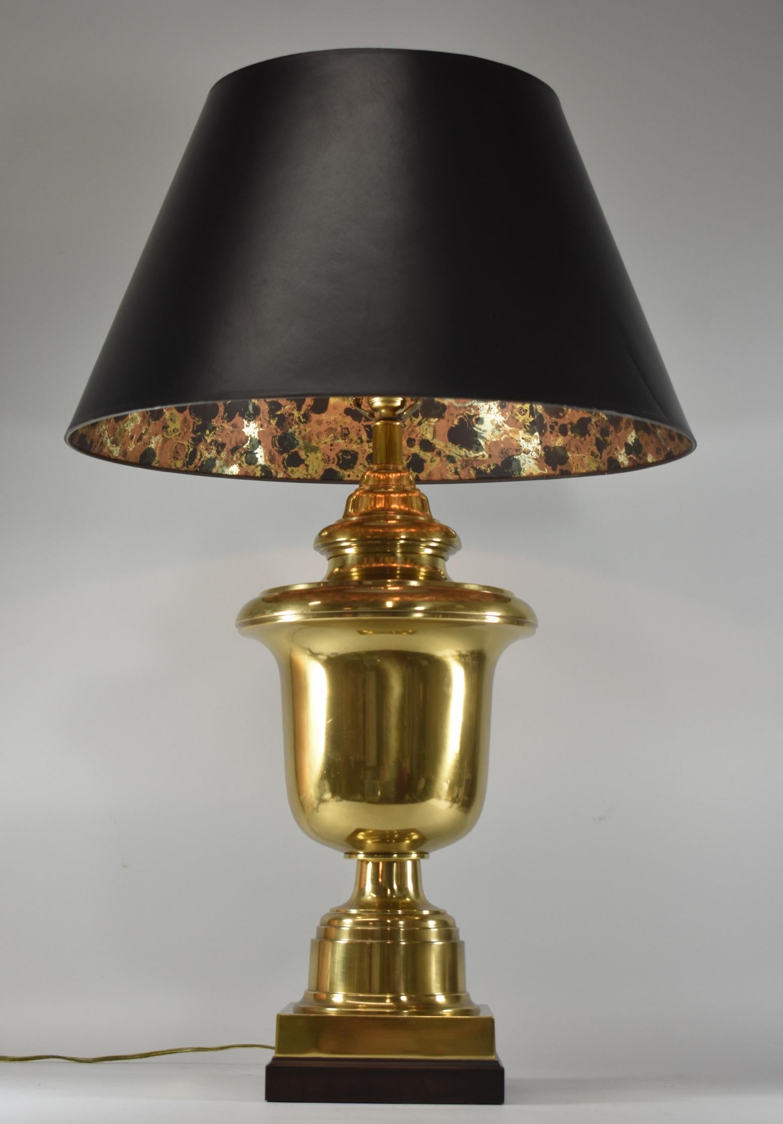Vintage brass urn shaped table lamp by Fredrick Cooper of Chicago. It is accented with a dark wood base. The shade is also Fredrick Cooper. Both lamp and shade are in very good vintage condition with only light surface wear. It measures 34