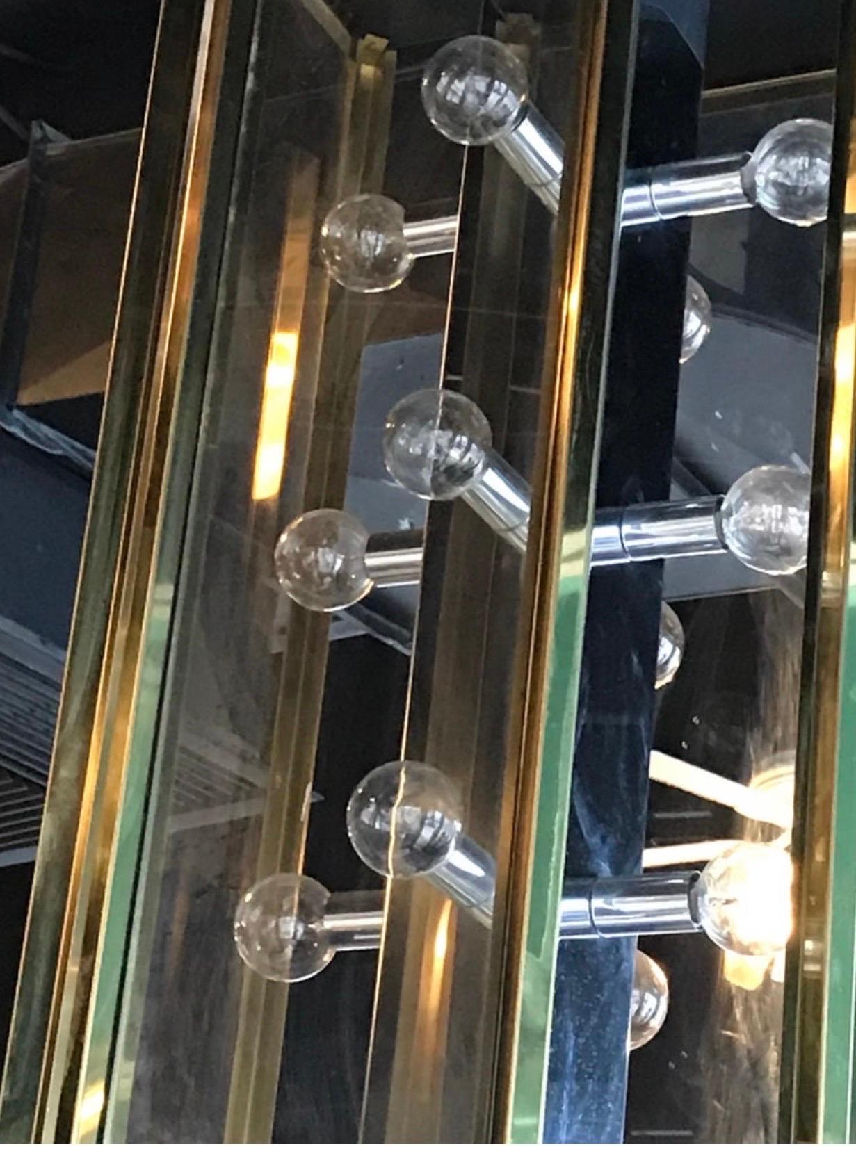 A fantastic example of the great designs of Mr. Fredrick Raymond, who had an amazing lighting company in Orange County, Calif. He was great at modern glamorous looking brass and chrome lighting that still looks great today. This large beauty was