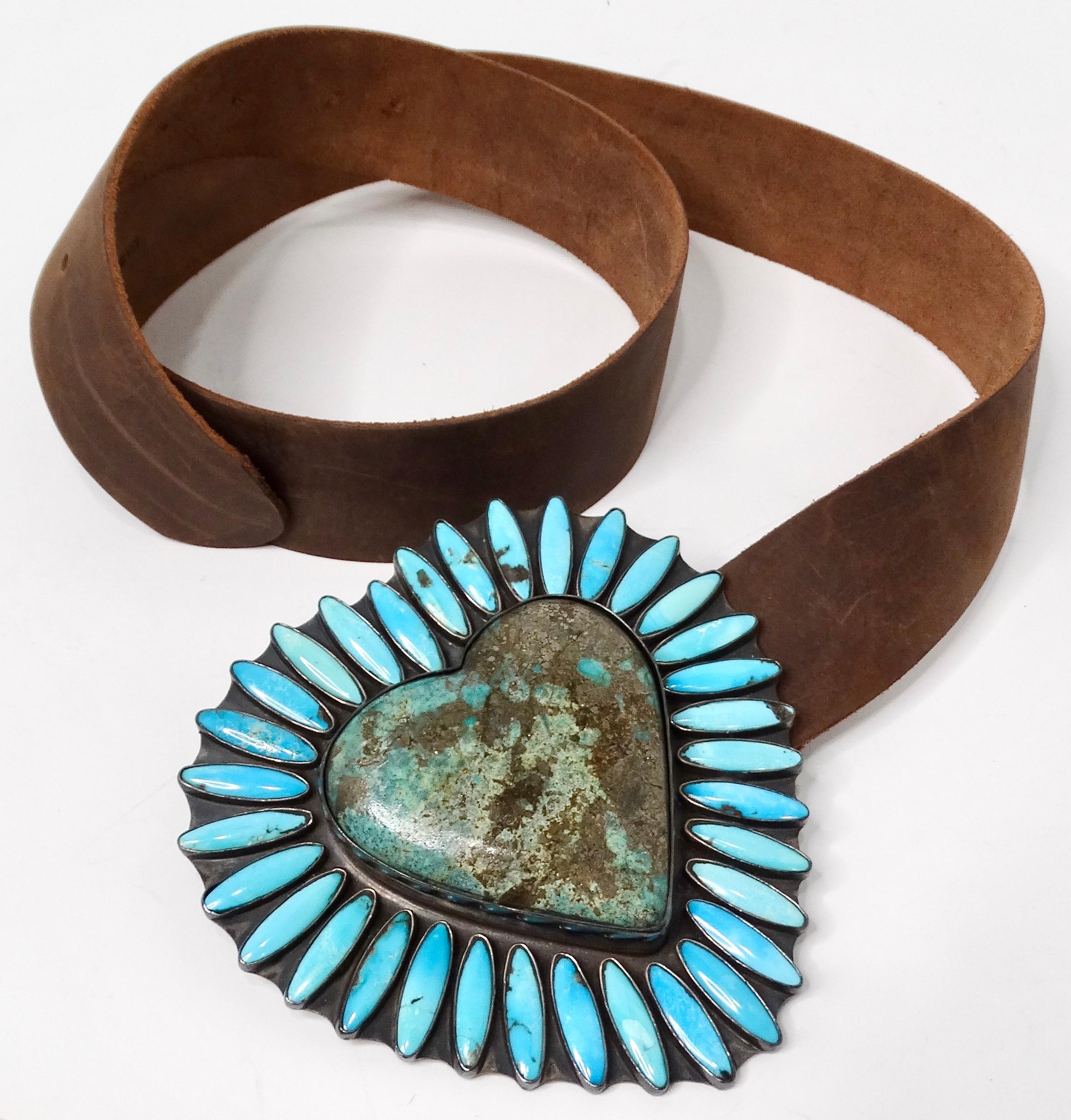 The Fredrico Jimenez Turquoise & Sterling Silver Heart Brown Leather Belt is a stunning accessory that merges Southwestern flair with contemporary elegance. Crafted from rich brown leather, this belt features a striking large buckle that showcases