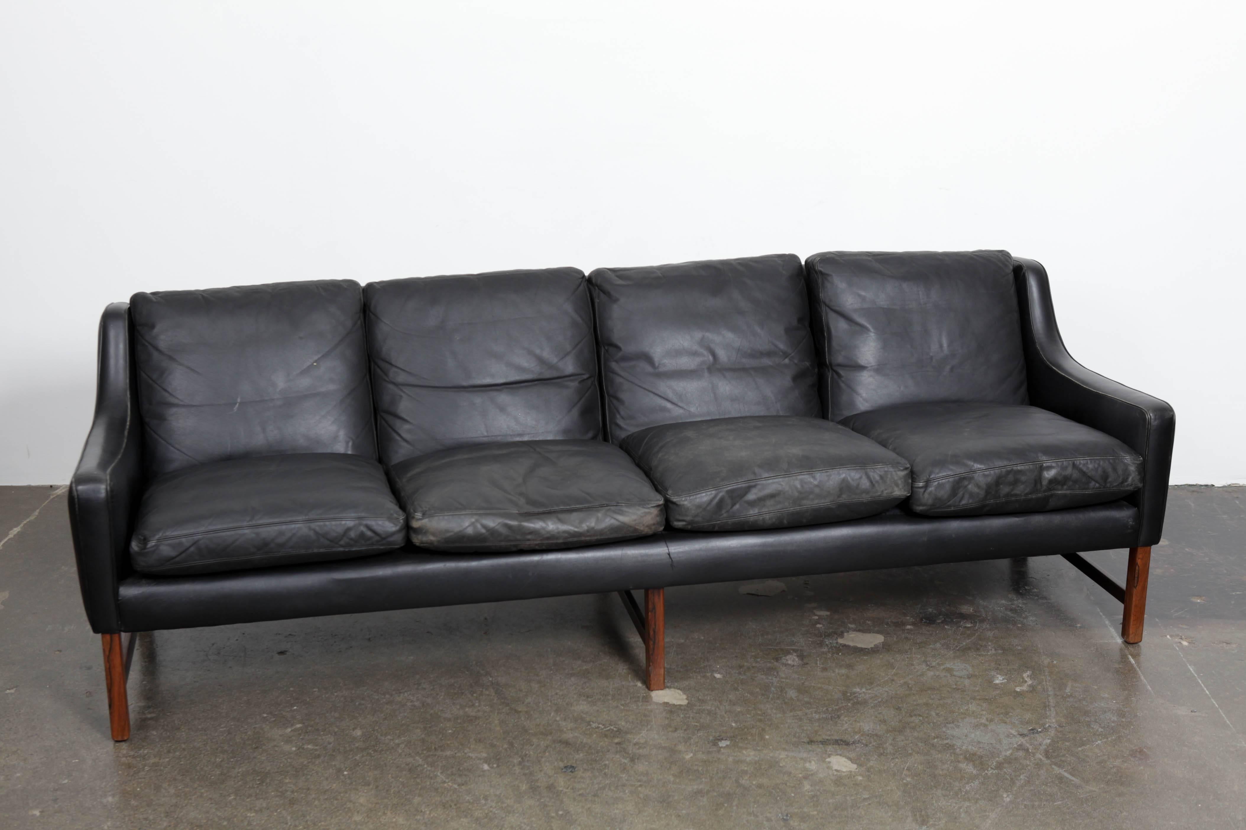 Norwegian four-seat sofa by Fredrik Kayser, in original black leather with rosewood legs. It shows some patina, but in a positive way, no damage or tears or issues at all.