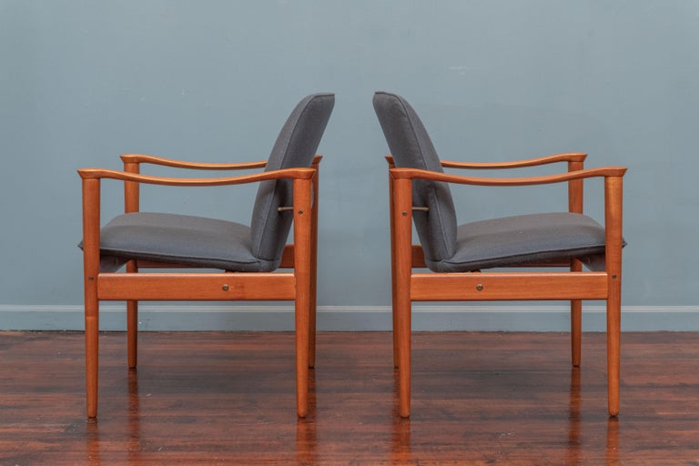 Fredrik A. Kayser design lounge chairs for Vatne, Denmark. Made from solid teak frames that have been newly refinished and upholstered in Knoll dark teak wool. Elegant chairs with sculpted arms that are ready to install and enjoy.