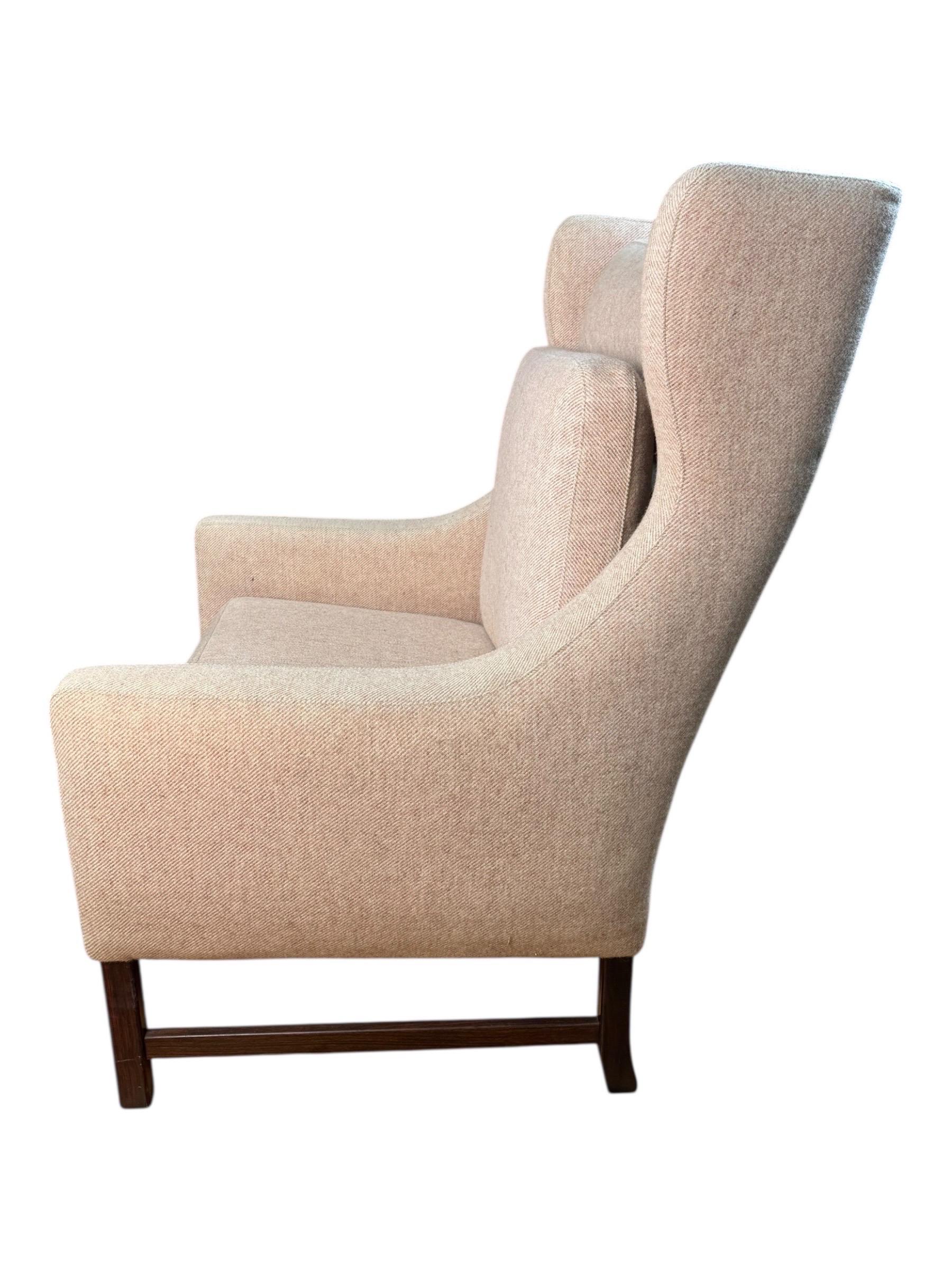 Up for sale is a stunning all-original mid-century chair crafted by Fredrik Kayser. This piece features a beautiful salmon-colored fabric and a rich rosewood base